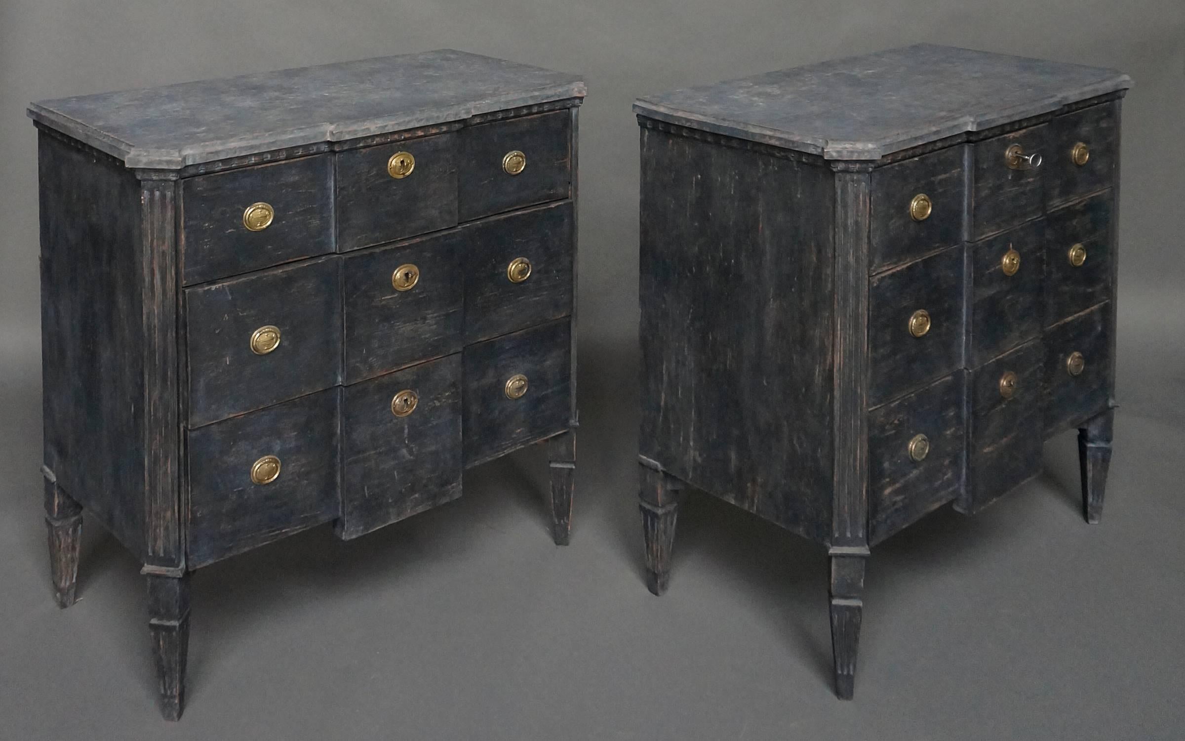 Pair of commodes in the late Gustavian style, Sweden, circa 1840. Three full-width drawers under a faux stone top with a dentil frieze. Canted corners with reeded corner posts which extend into tapering square legs. Versatile small size.