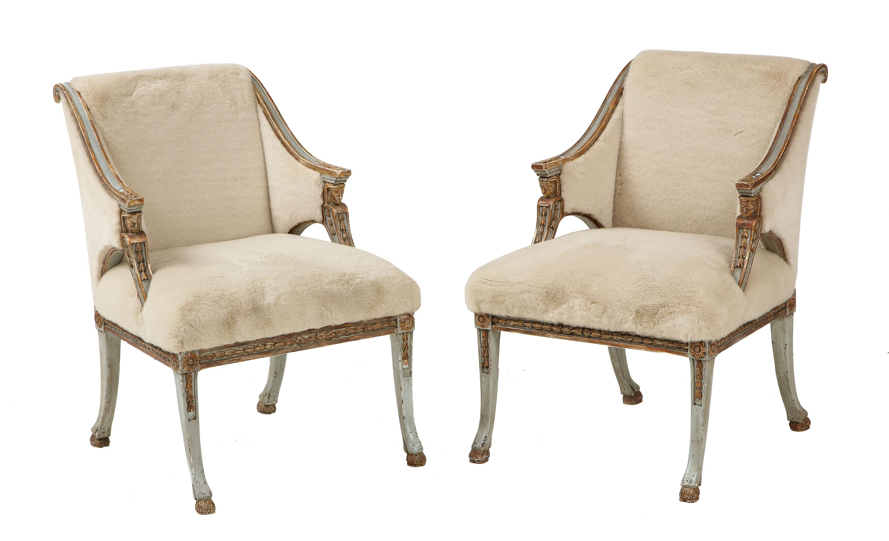 Each with a square upholstered back carved with back scrolled ears flanked by arms carved with bellflowers supported by classical figure heads centering an attached seat, the rails similarly carved all on sabre legs ending in hoof feet.
