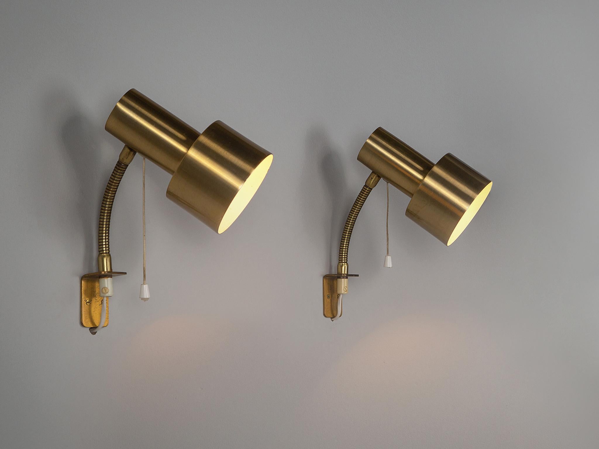 Wall lamps, brass, Sweden, 1960s.

Attractive and chic Swedish wall lamps with brass shades, adjustable stem and pull cords. A simplistic yet smart set of wall lamps.

Please note that we have more in stock. These items are in good, used condition.