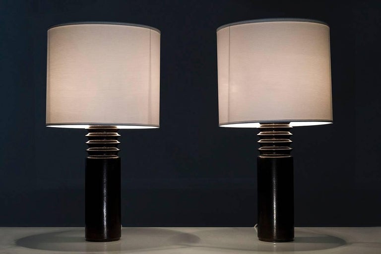 Pair of bronze colored ceramic table lamps by Luxus, Sweden. 
The shape of the lamps combined with the bronze surface gives the lamps a rough, Brutalist touch, typical for its age.
Condition: Very good
Please note that the shades are not included.