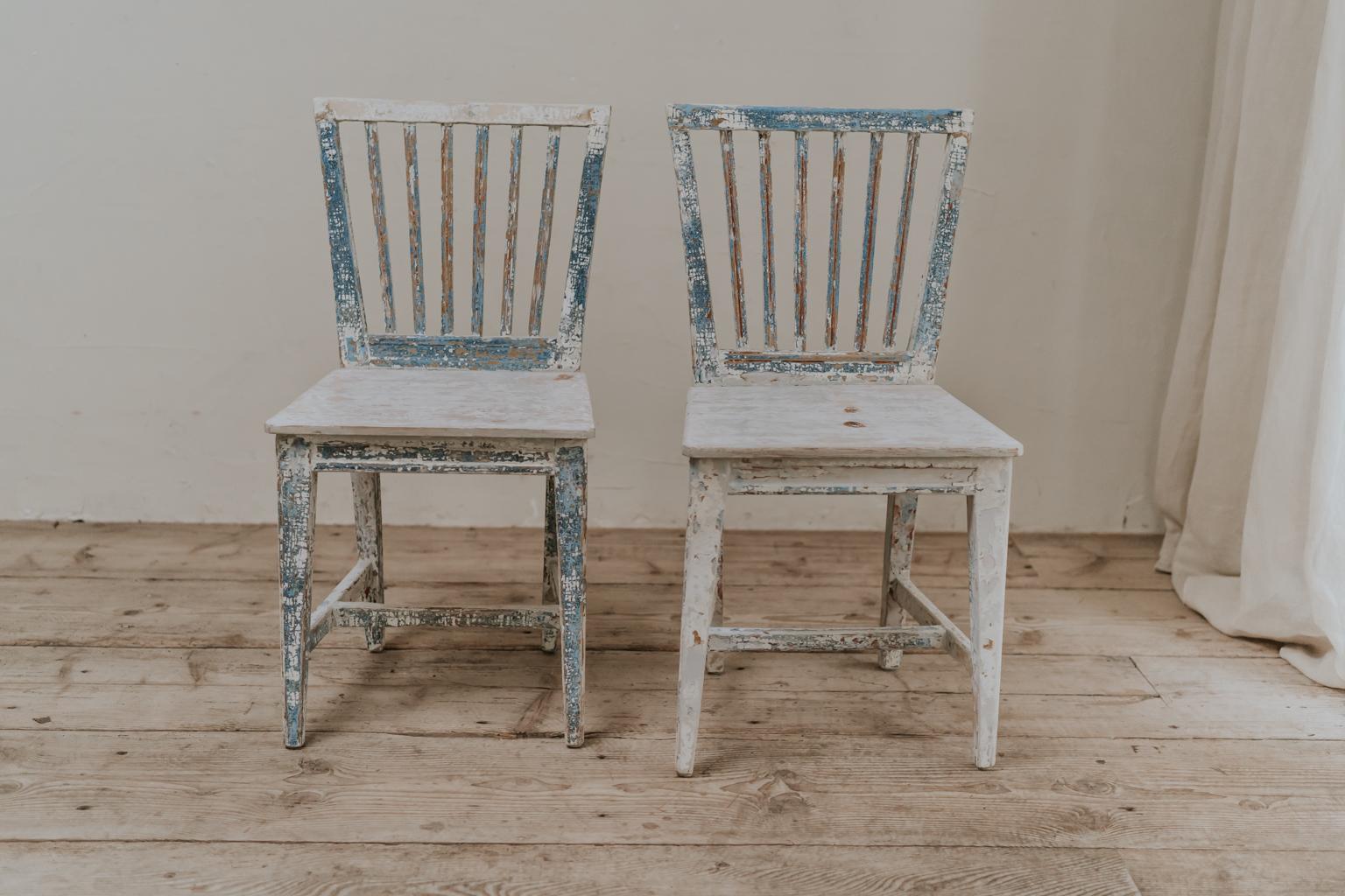 A charming pair of 19th century Swedish chairs, crusty old paint on pinewood.