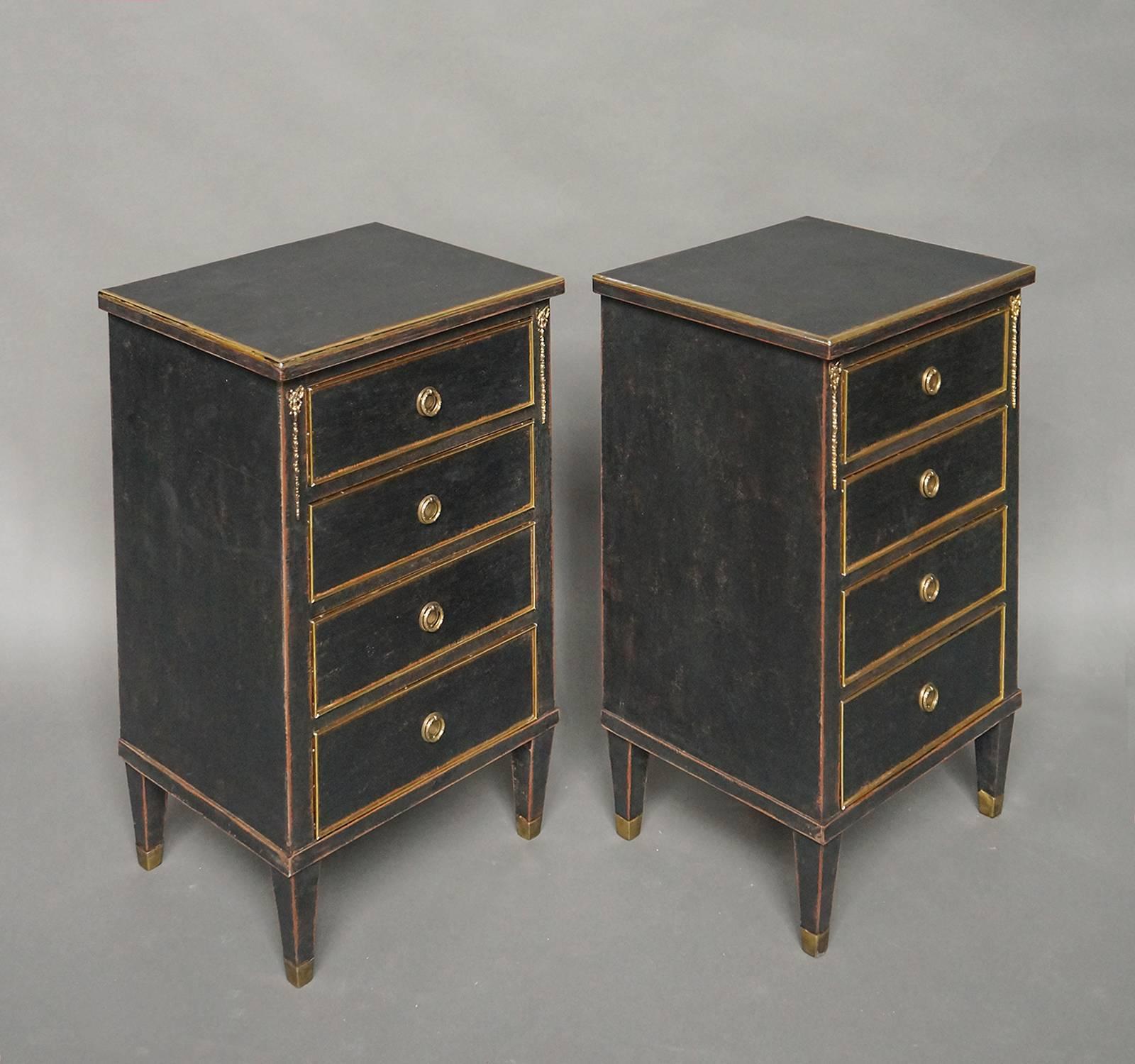 Pair of small Swedish four-drawer commodes, circa 1900, with the feet, the tops and the drawer edges cased in brass. At the upper corners are applied brass bows. These commodes would work well as nightstands.