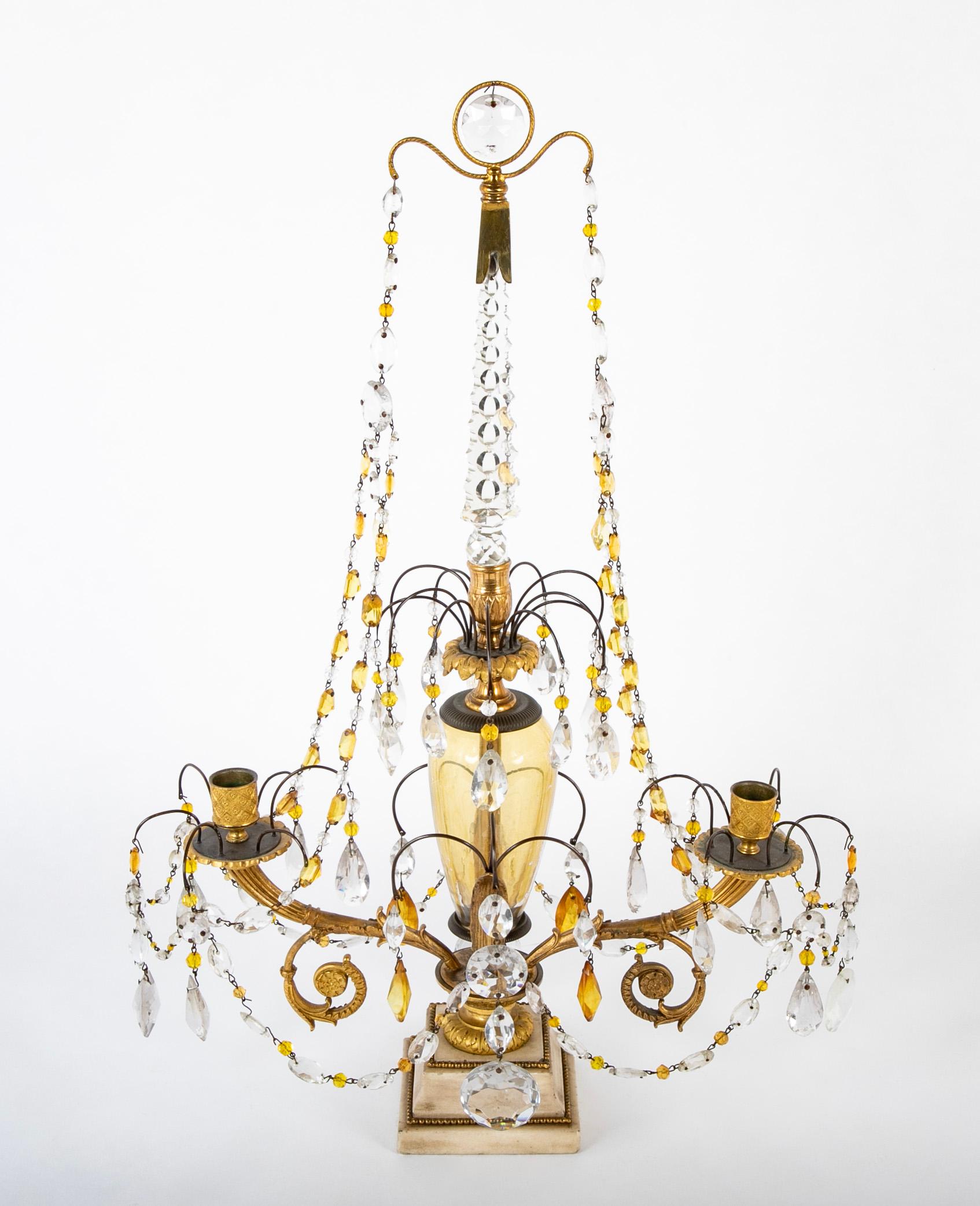 Pair of Swedish crystal candelabra having canary yellow centers and bronze arms & fittings resting on white marble bases. 