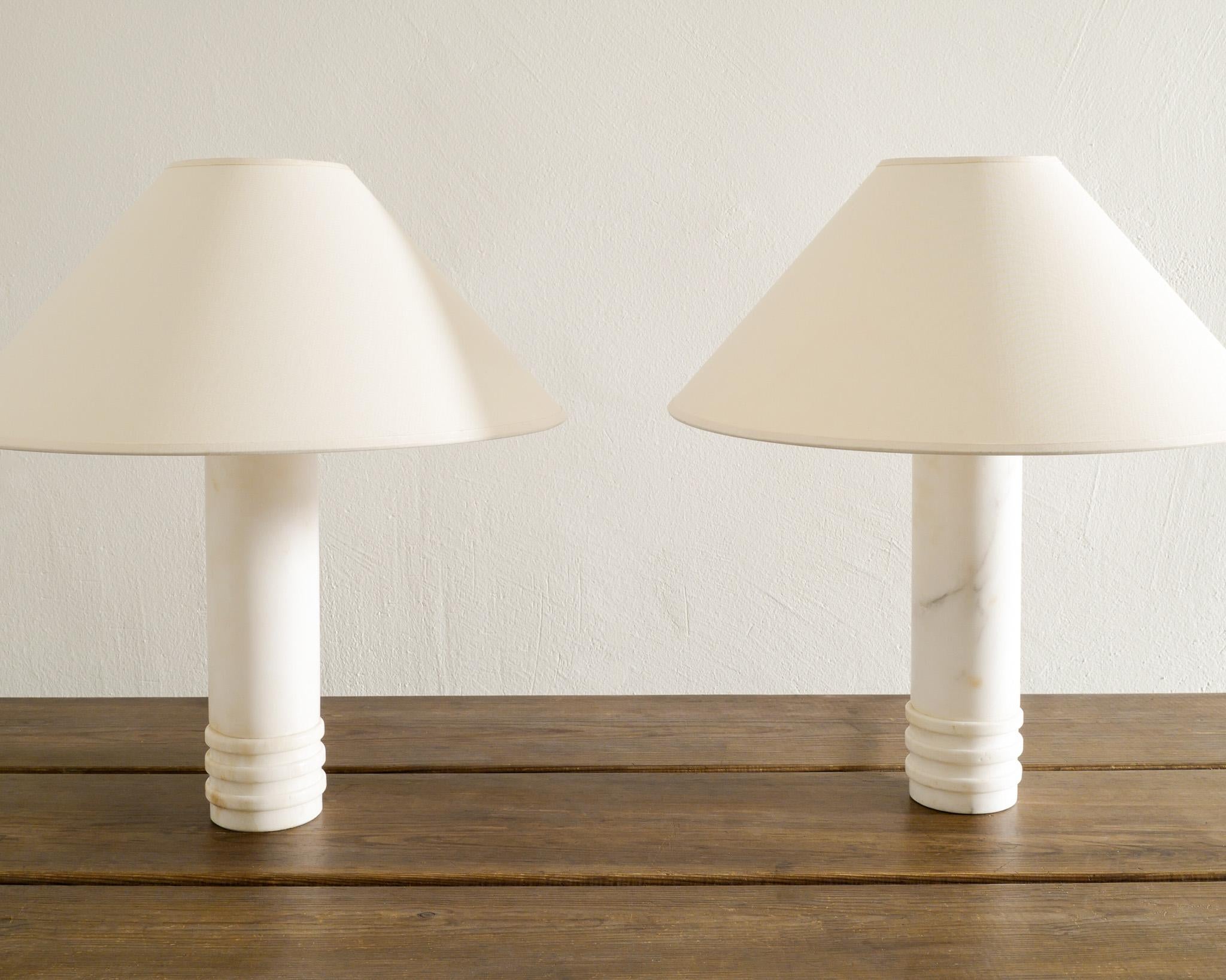 Rare pair of Swedish mid century cylinder table / bed lamps in solid white  marble produced by Bergboms Sweden 1960s. In good original condition with newer wiring. Signed. 

Dimensions: H: 34 cm / 13.4