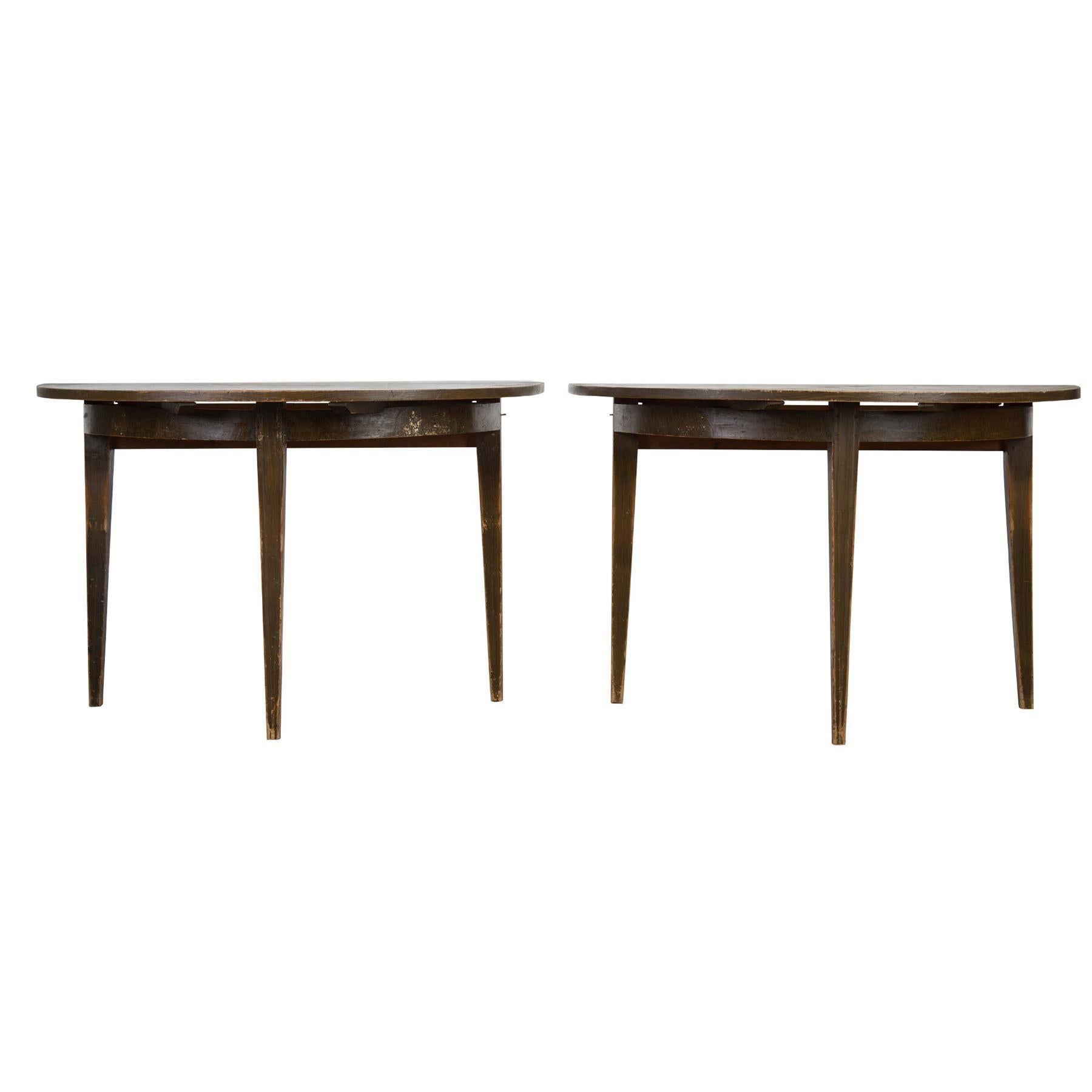 A pair of 18th century Gustavian demilune tables in original paint.