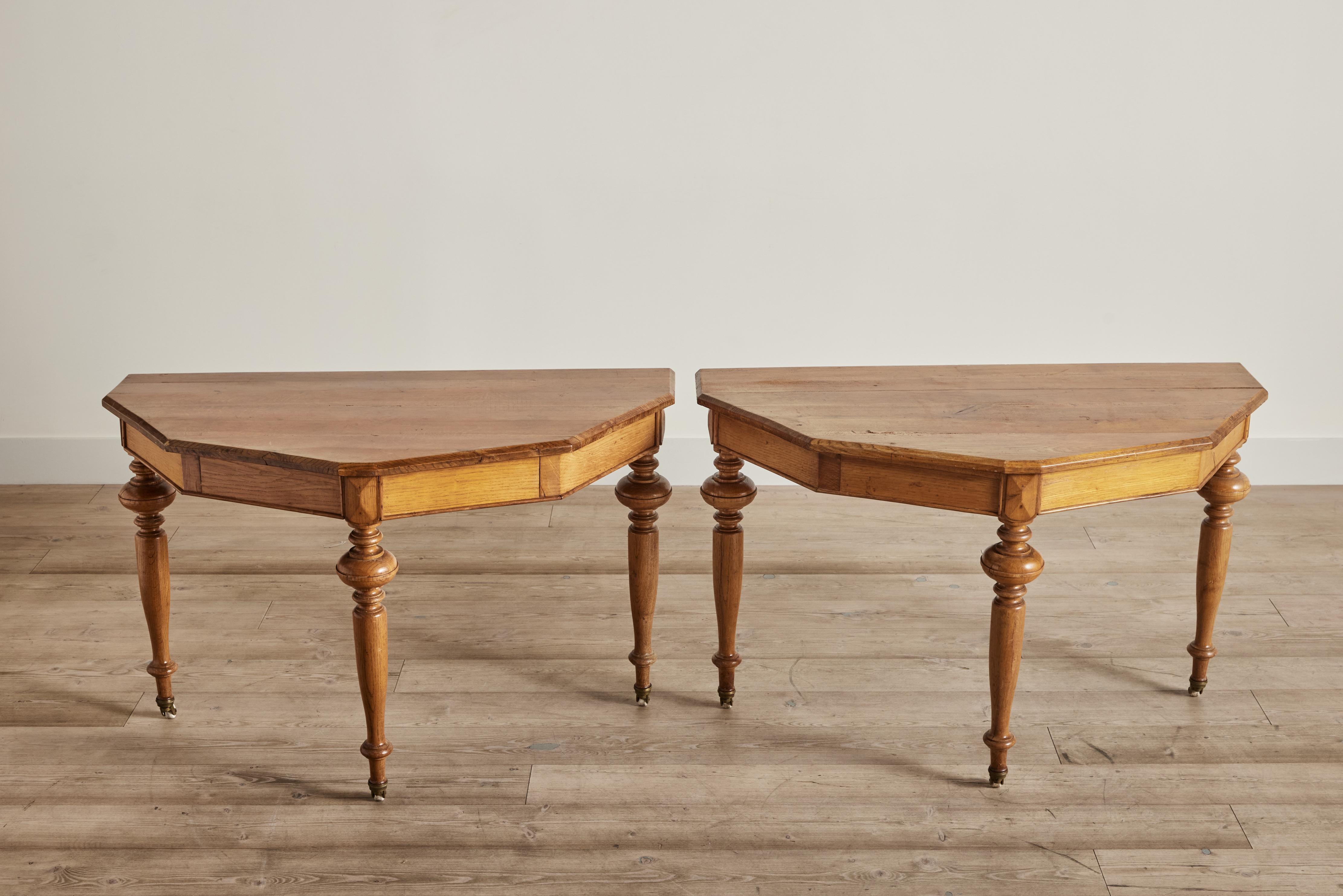 Pair of 19th century Swedish demilune tables showcasing the simplicity and elegance of Swedish style with graceful silhouettes and a rich wood finish. These tables can be used separately or joined as one table to offer versatile functionality while