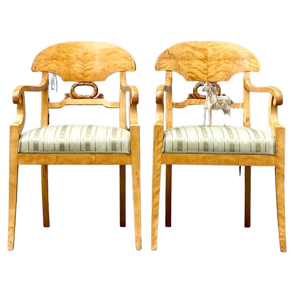 Pair of Stockholm Birch Wood Armchairs in the Empire / Karl Johan period, circa 1810-1830 Sweden.
This Swedish pair of armchairs are veneered in a warm golden honey color. Style is a classic design with one carved center decoration. Slight sabre