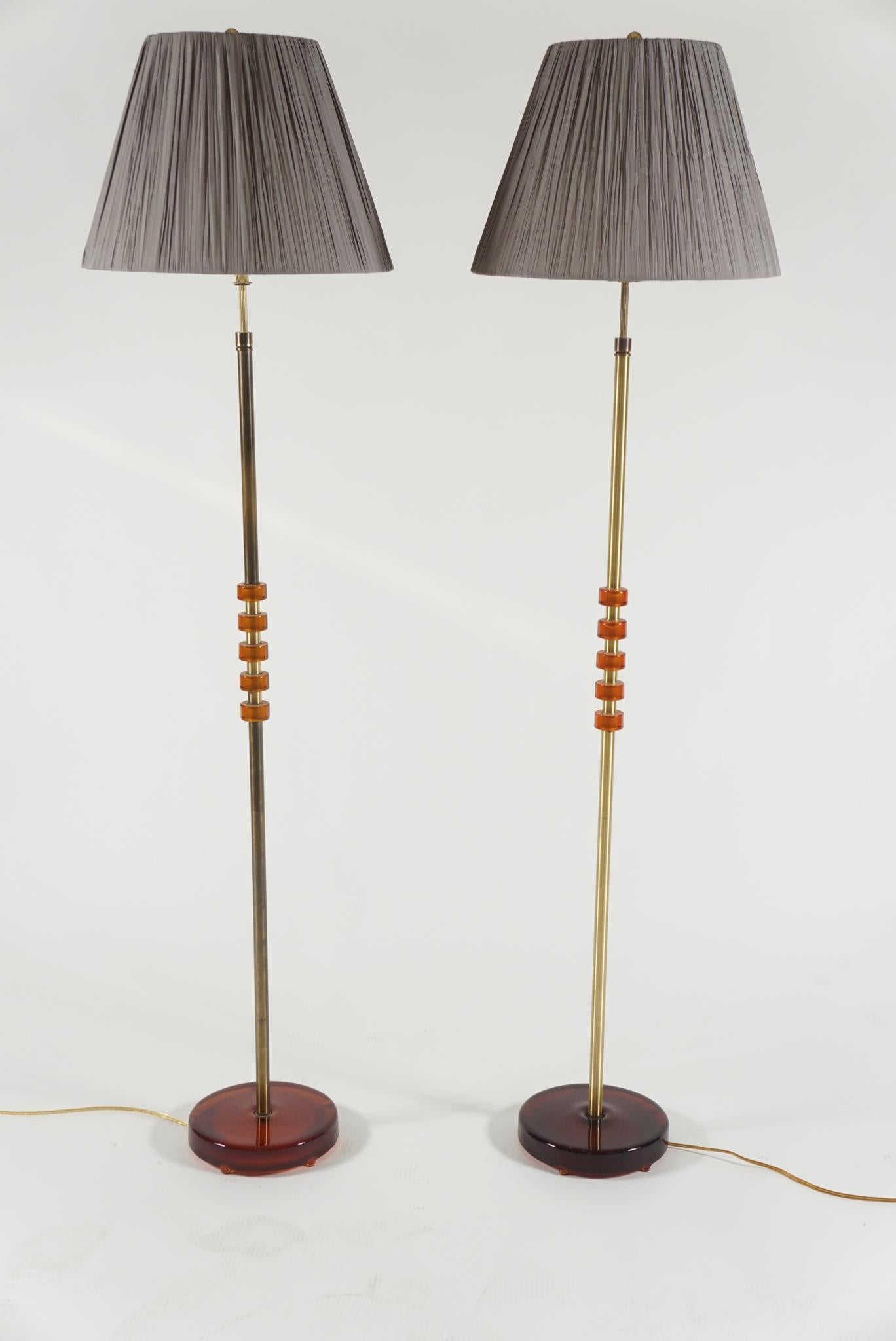 Pair of stylish brass and amber glass floor lamps from Orrefors of Sweden by Carl Fagerlund, circa 1950s
The base being glass also.