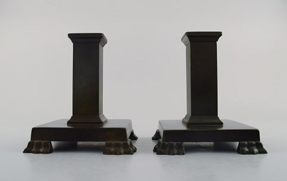 A pair of Swedish GAB (Guldsmedsaktiebolaget) Art Deco candlesticks in bronze. 
1930/40 s.
Measures 12 cm. x 9.5 cm.
In very good condition, beautiful patina.