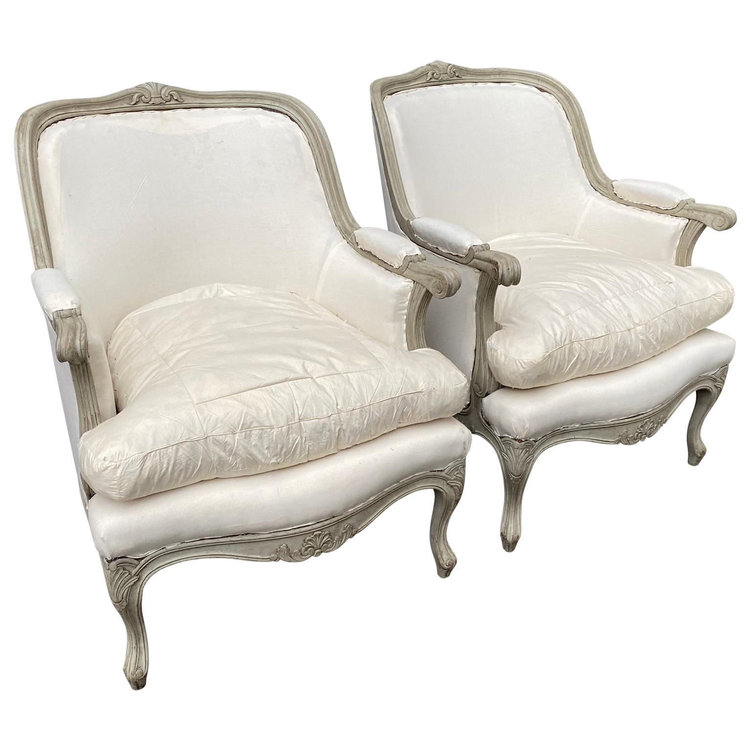 A pair of Swedish grey painted armchairs of the bergere model from the early 20th Century.

 