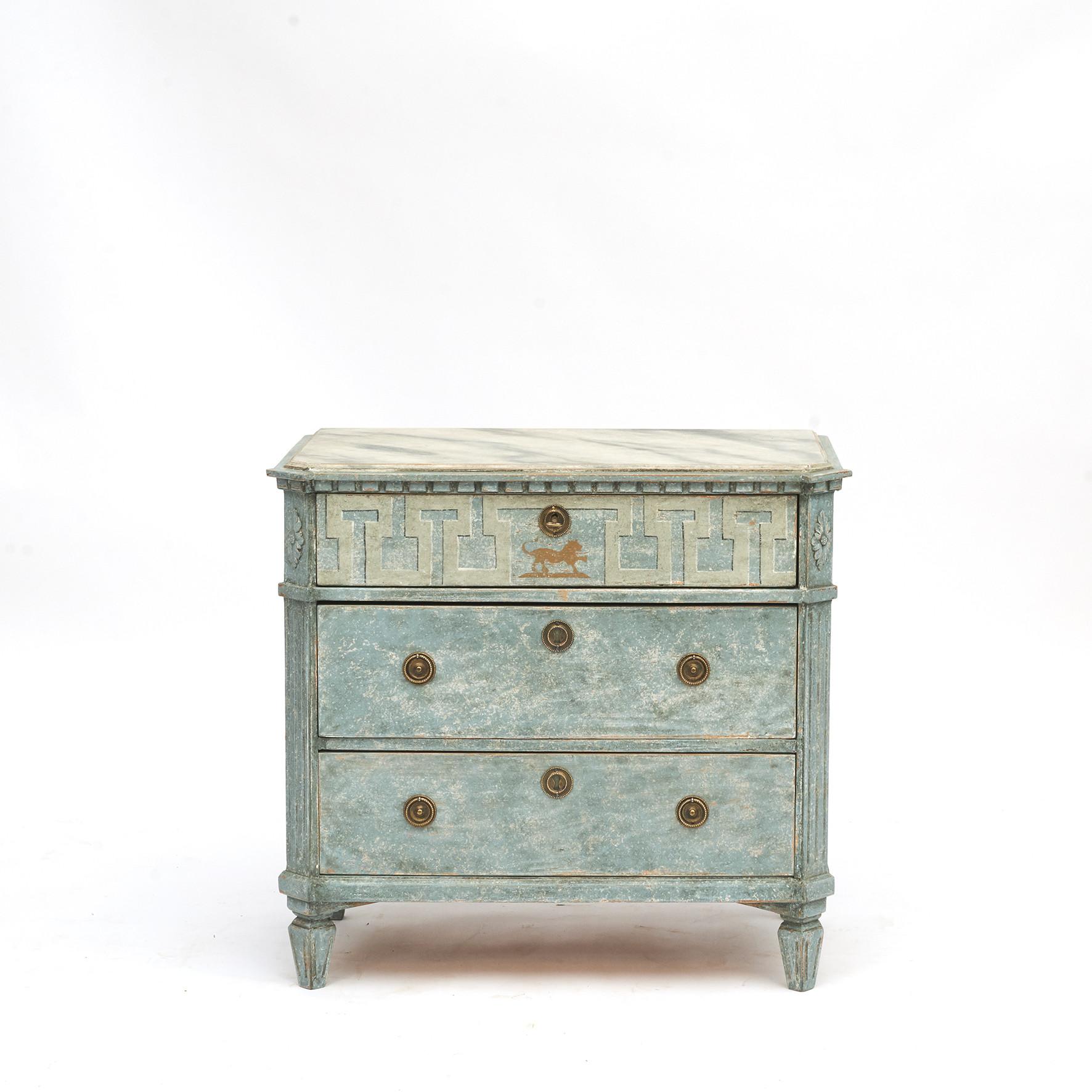 Pair of Swedish Gustavian style chest of drawers.
Each of this pair of Gustavian style painted chests features a rectangular marbled top with canted corners in the front, sitting above an elegant apron adorned with dentil molding.
Three drawers.