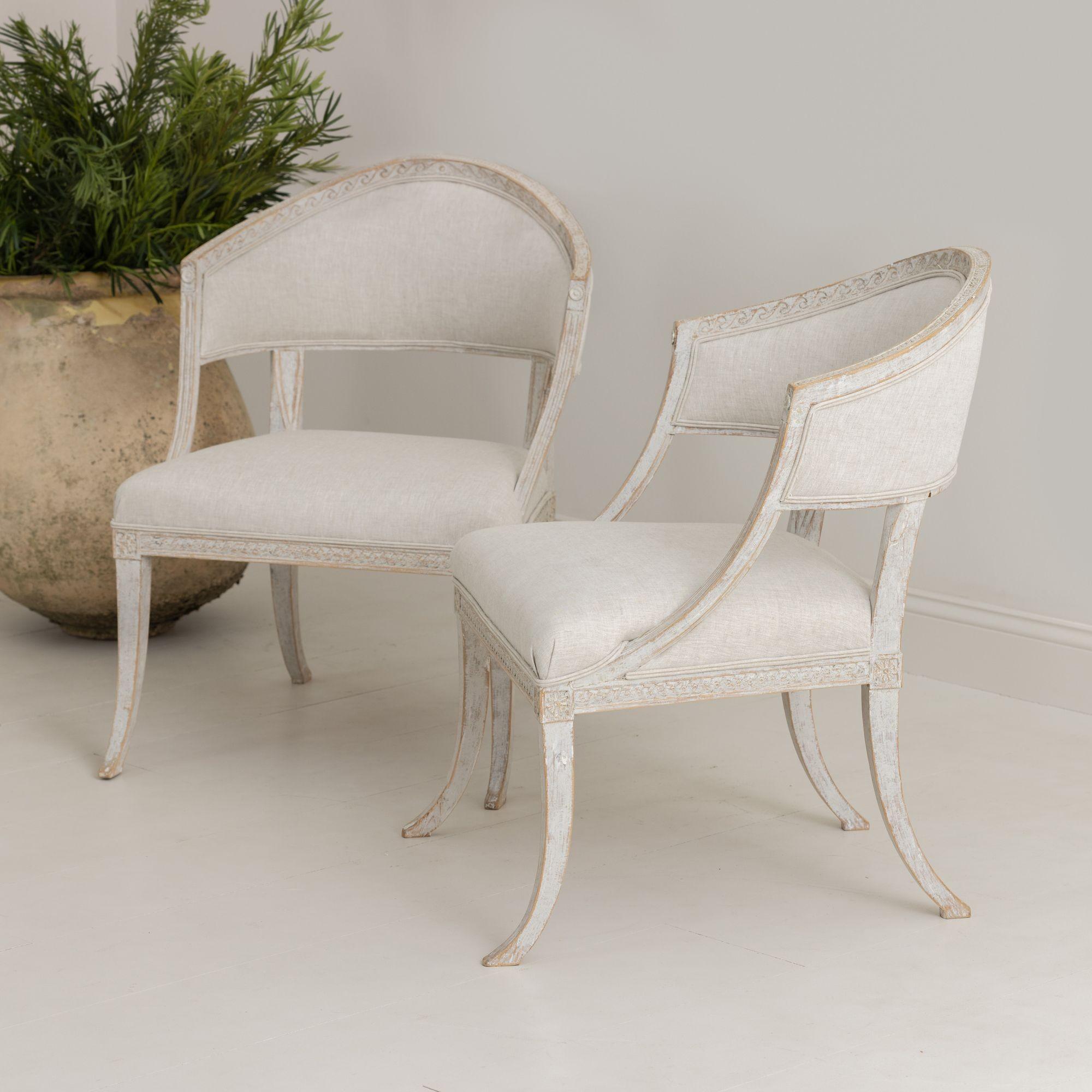 A pair of Swedish chairs with classic sulla, barrel backs in the Gustavian style with wood carved decor, four splayed legs, and newly upholstered in linen.


We offer expedited, fully-insured, custom packaged / crated, global shipping, including