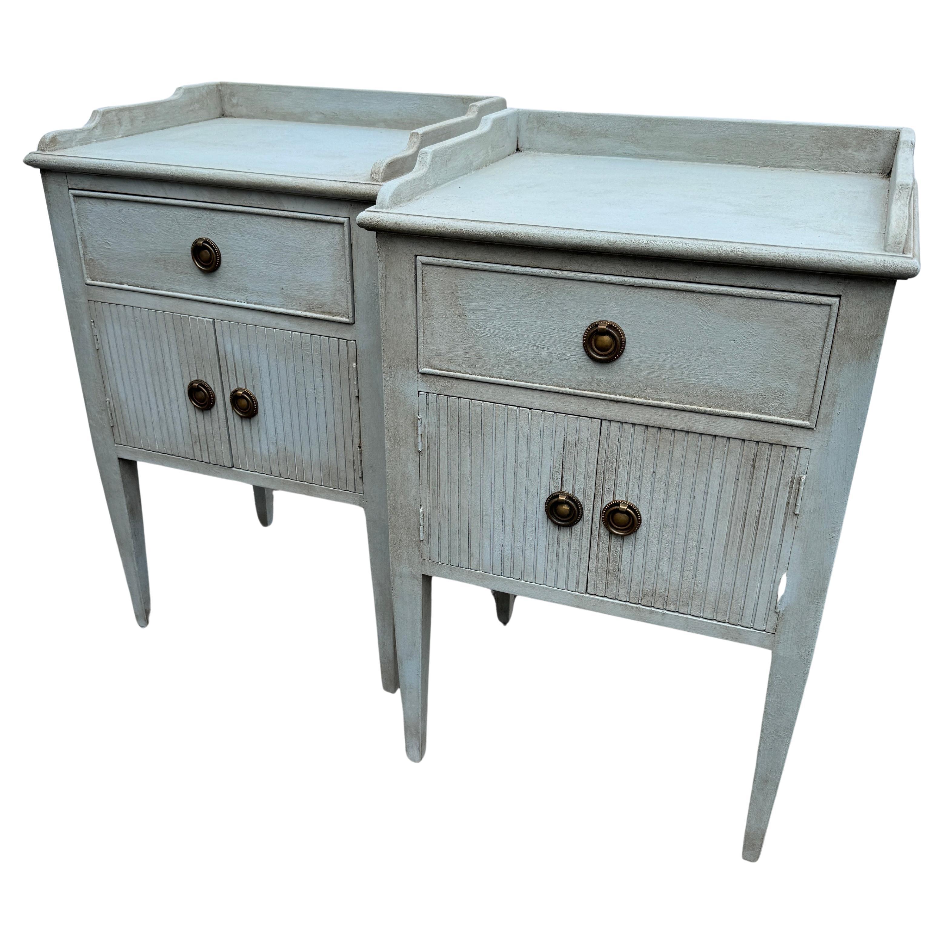 This pair of Swedish style single drawer with cabinet below Swedish blue nightstand or bedside tables have been constructed from solid wood. Classic details on this set including a hand-applied finish and feature bronzed ring hardware. This pair has