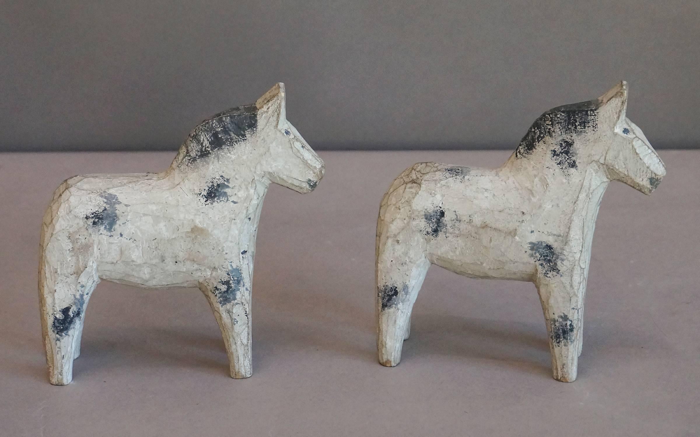 Pair of Swedish horses from Dalarna, circa 1900. Flat-plane carving painted with blue and gray detail.
