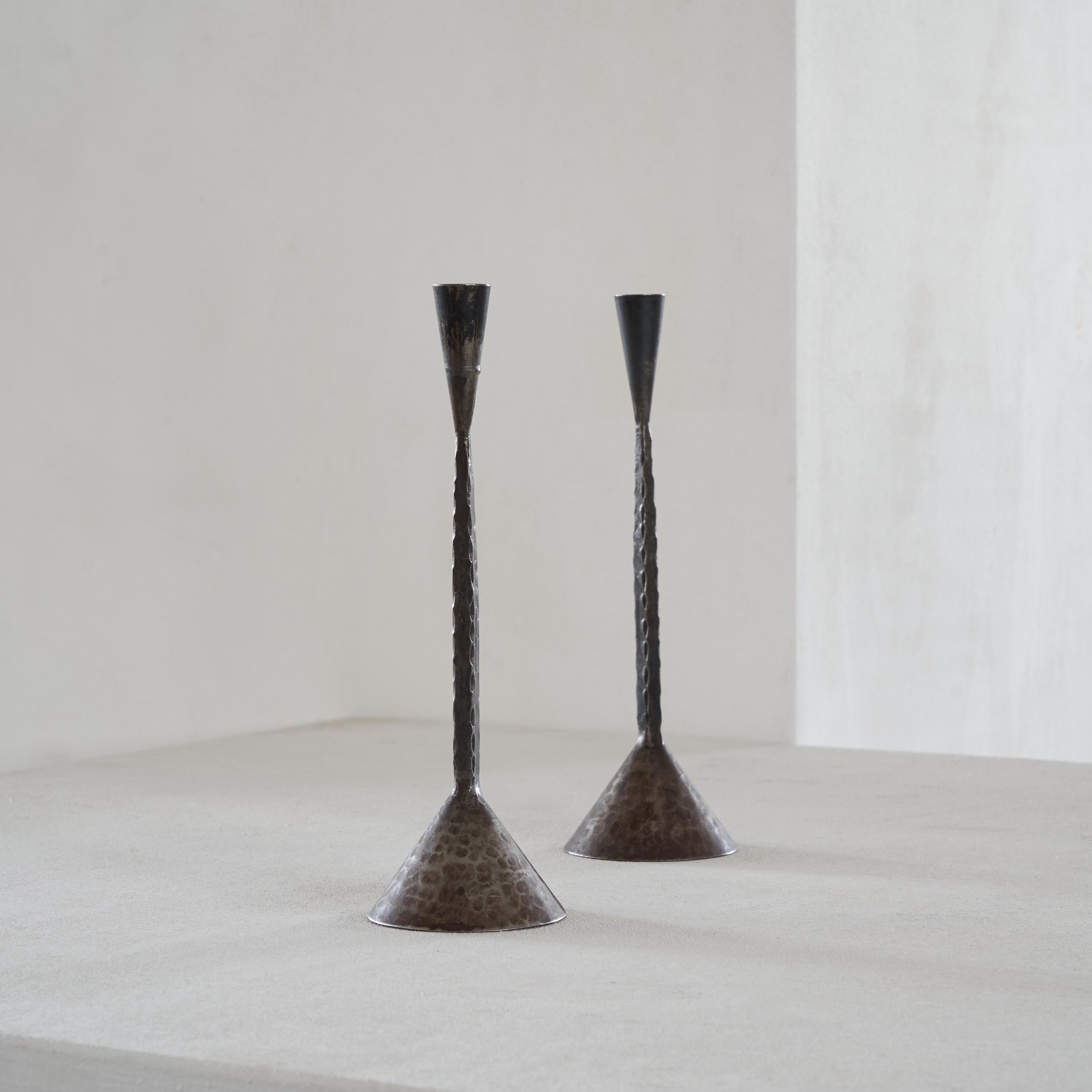 Pair of hand hammered mid-century brutalist candlesticks made in Sweden. 

Very elegant and simple pair of candlesticks with perfect proportions and great details. Hand made in Sweden somewhere in the middle of the last century. 

Good vintage