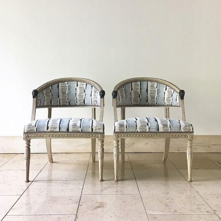 Pair of Empire chairs in original worn painted carved frames adorned with Verdi Gris lion masks to the sweeping arms, circa 1800.
The front legs are decorated with flora and are turned and the rear legs are sabre shaped. 


 