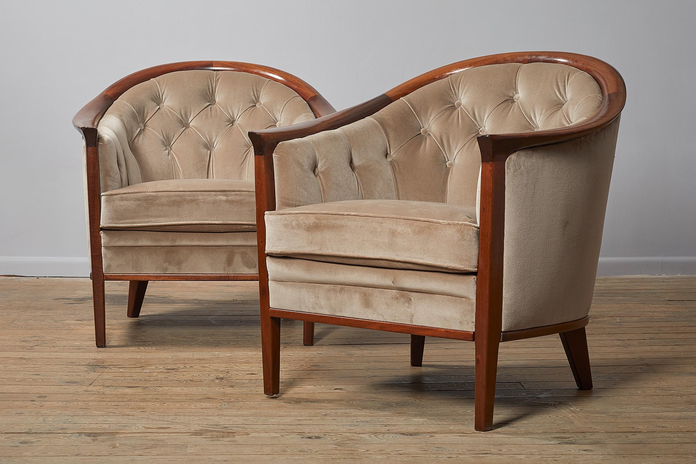 Pair of Swedish upholstered mahogany 'Aristokrat' club chairs by Bertil Fridhagen, circa 1960. The chairs are of generous proportions and are rounded in form. Polished dark wood frames, with light cream velvet upholstery using Pierre Frey Opera