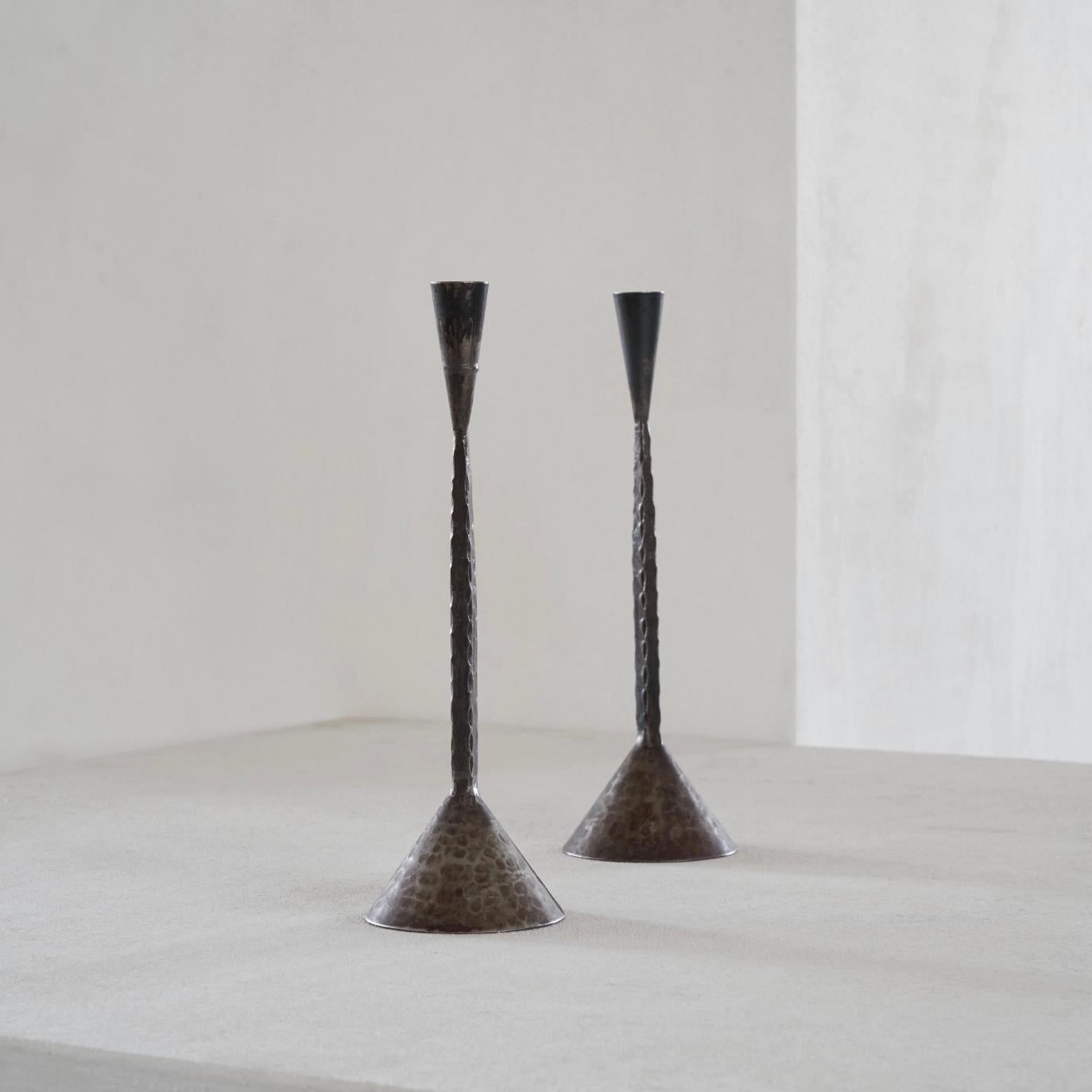 Pair of hand hammered mid-century brutalist candlesticks, mid 20th century, Sweden.

Very elegant and simple pair of candlesticks with perfect proportions and great details. Wonderful combined with natural materials like wood, but also a great