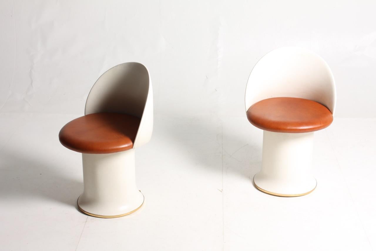 Pair of rare stools in patinated leather, brass and vinyl. Designed by Halvdan Peterson for Tibro Møbelfabrik, circa 1950. Great condition.