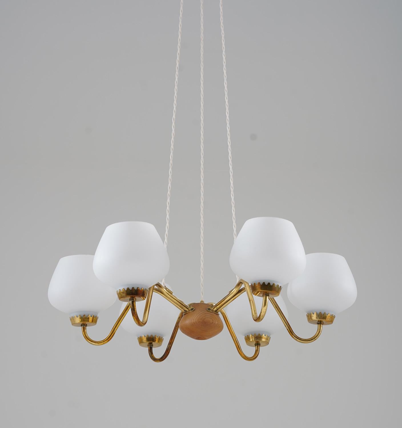 Midcentury pendants in brass, wood and frosted opaline glass manufactured by ASEA, Sweden, 1940s.
These great-looking pendants are made with high quality and great details. They feature six light sources, hidden by frosted opaline glass shades. The