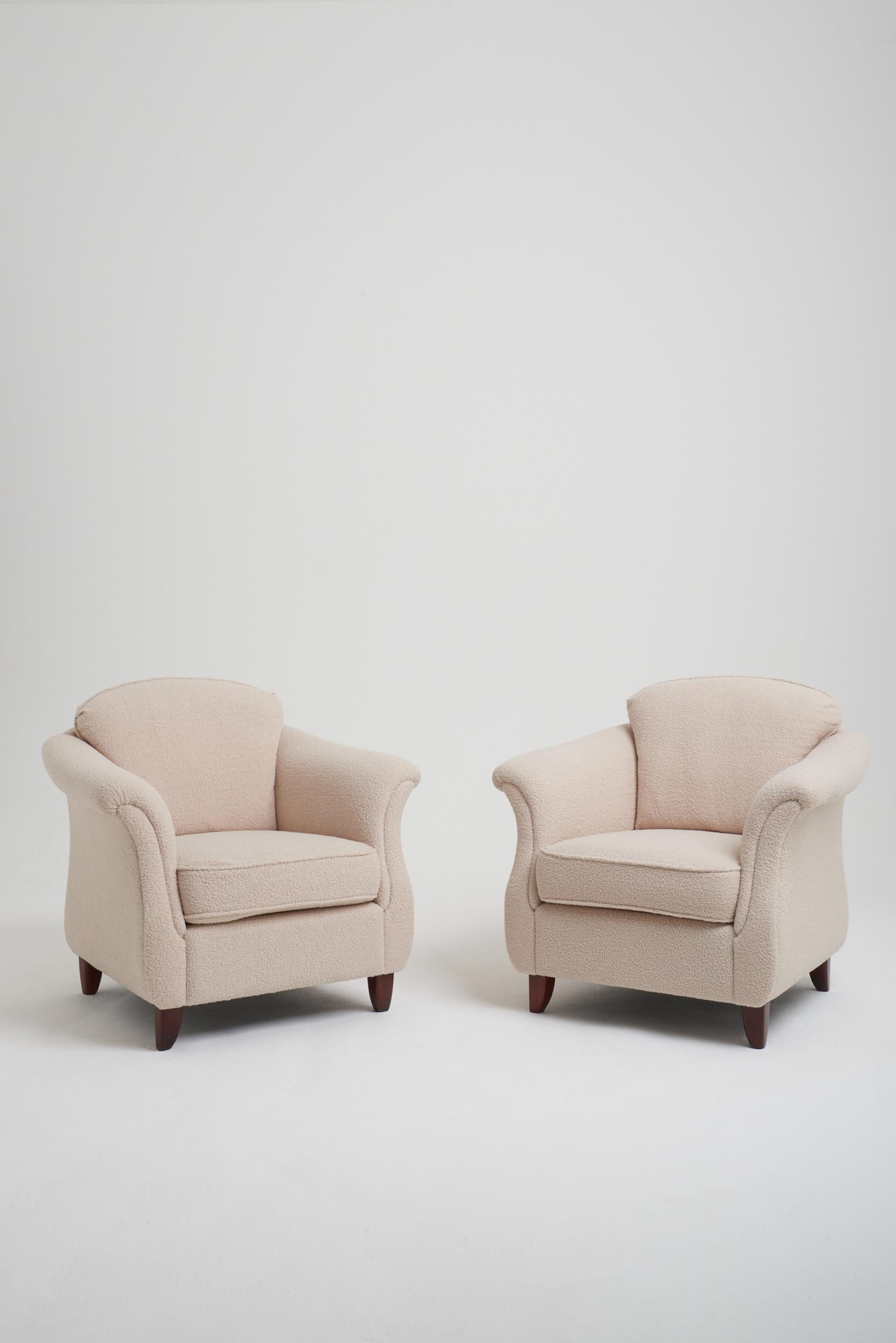 A pair of Swedish Modern armchairs, upholstered in bouclé.
Sweden, third quarter of the 20th century.