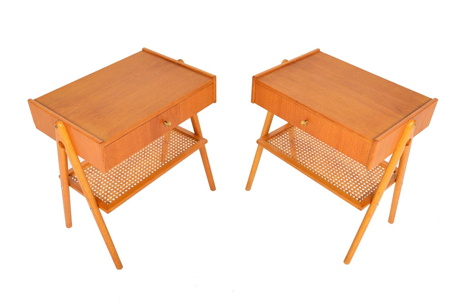 This handsome pair of Swedish modern midcentury nightstands blend form and function seamlessly. A single pullout drawer provides storage for smaller items. A lower rattan shelf provides additional storage. Case stands on oak v-legs. In excellent
