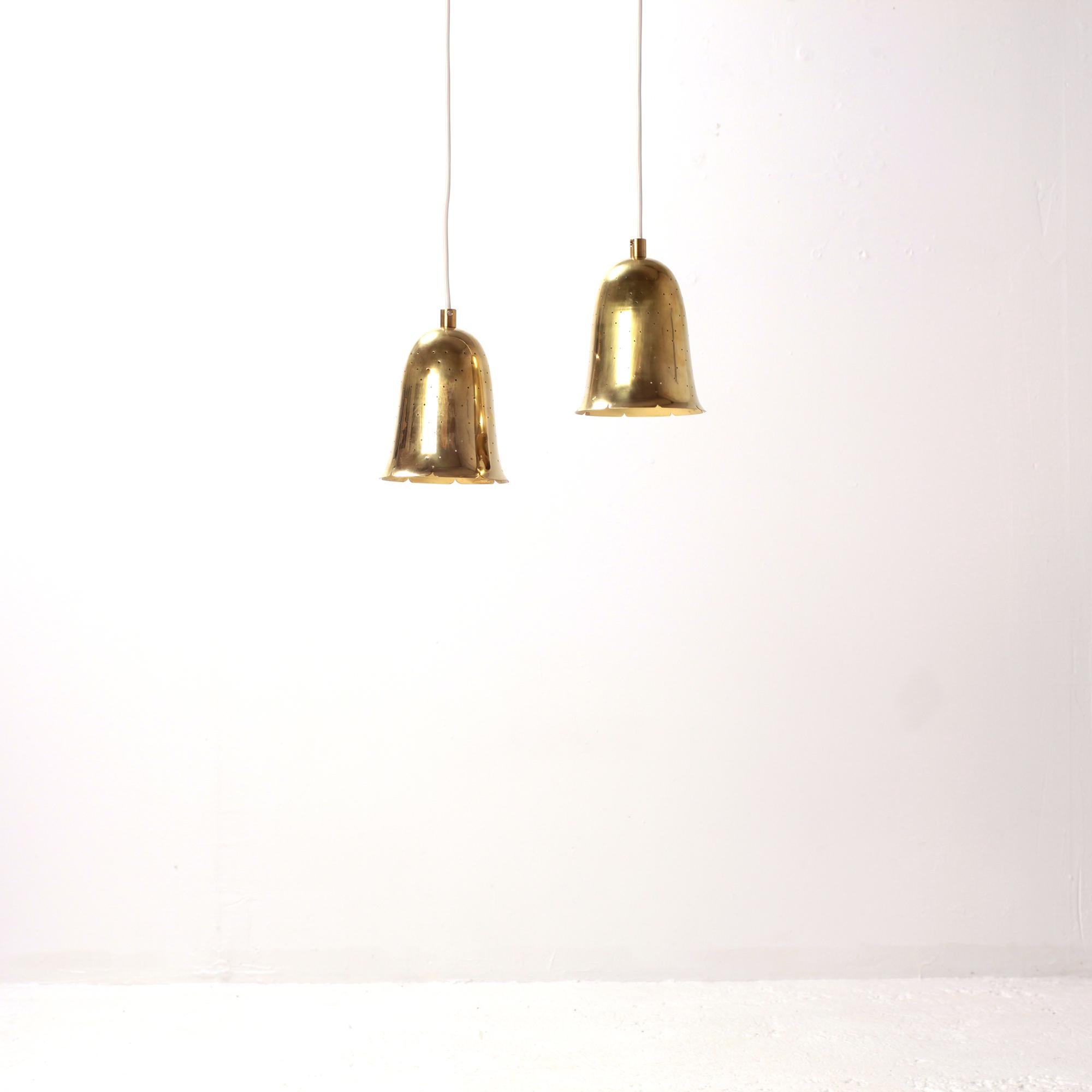 Brass bell shaped pendant lamps produced by Boréns at Borås in Sweden during the 1950s. 
Lamps made out of perforated polished solid brass. 
Very good condition with nice patina.

New electricity E27 bulb 