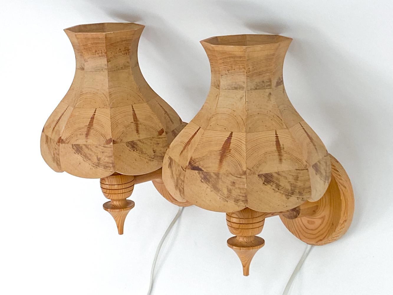 This fabulous pair of sconces brings the coziness of a Swedish cabin to your home! 
Crafted from solid pine, these lights bring organic texture and natural warmth to any space. The design is elevated by vase and ring turnings, which lend a
