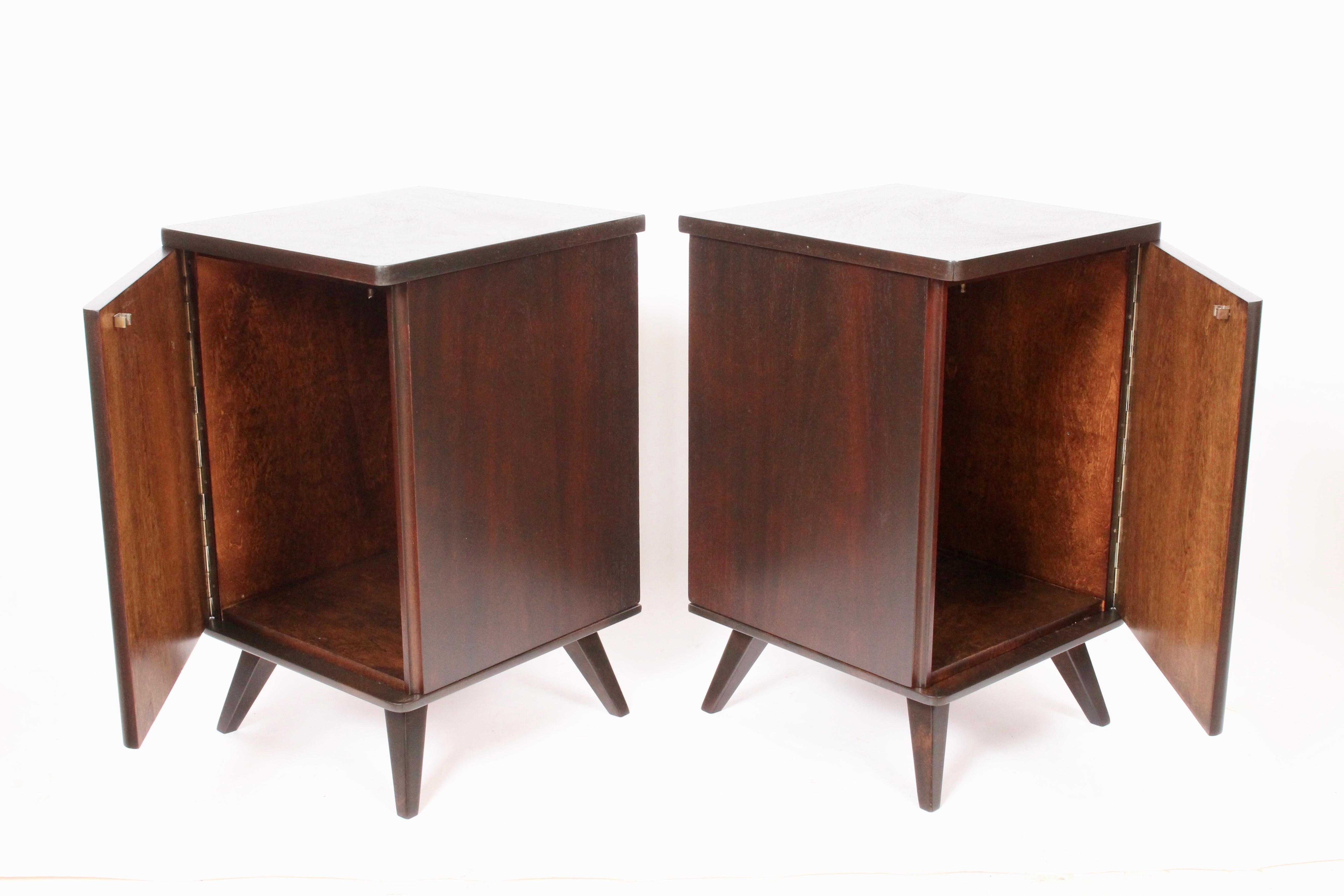 Pair of Swedish handcrafted dark walnut Bedside Cabinets, circa 1950. Featuring a finely crafted, sturdy square, beautifully grained Walnut frame on splayed legs with single piano hinged swing door providing large interior storage space. Stamped