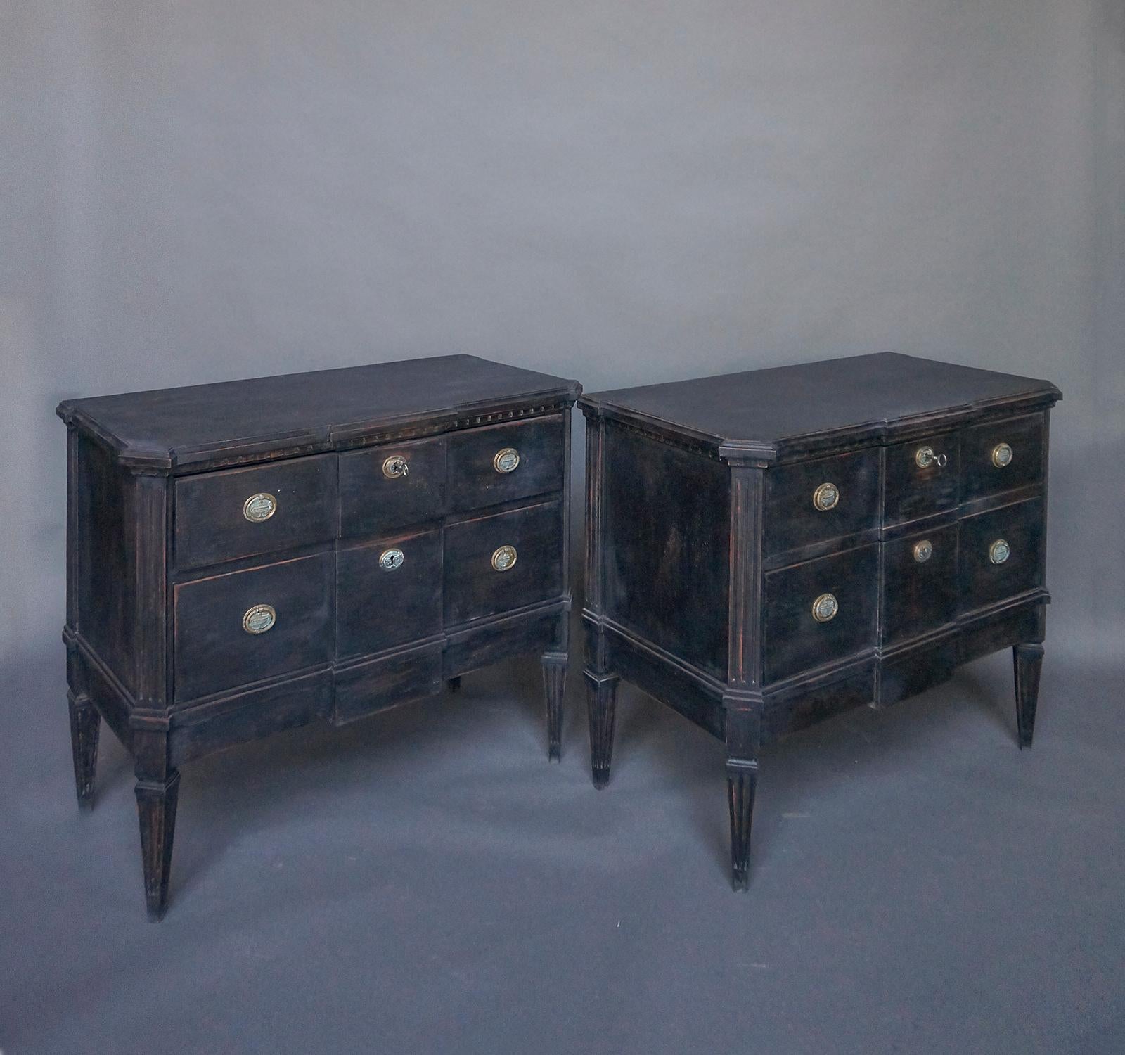 Pair of neoclassical block-front two-drawer commodes, Sweden circa 1850, raised on later bases.  Shaped tops with Dentil molding under the tops.  Canted corners and tapering square legs. Brass pulls and escutcheons.