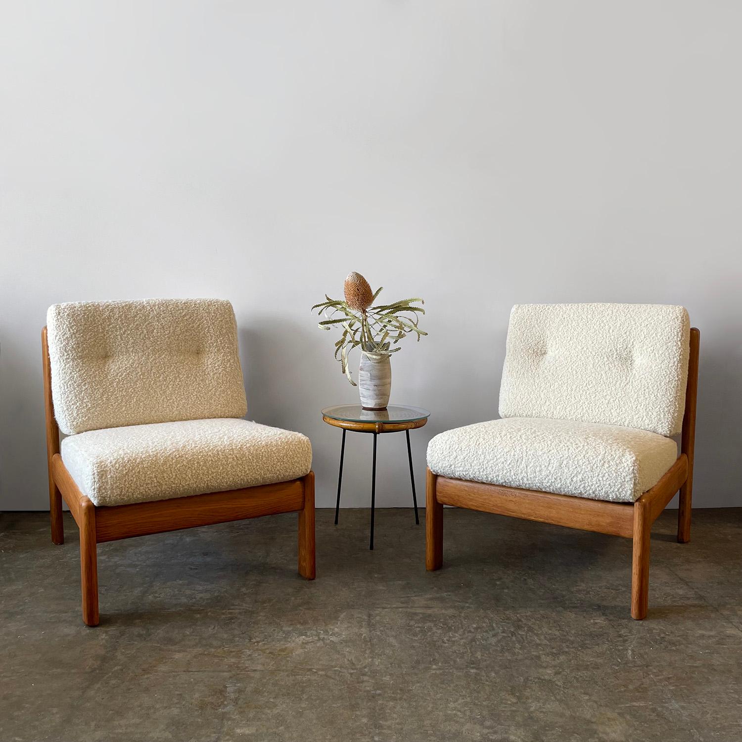 Pair of Swedish oak lounge chairs
Sweden, circa 1960’s
Aged oak frames have beautiful wood grain and color variations throughout 
Patina from age and use
Cushions have been newly reupholstered in buttery soft bouclé fabric
Additional photos