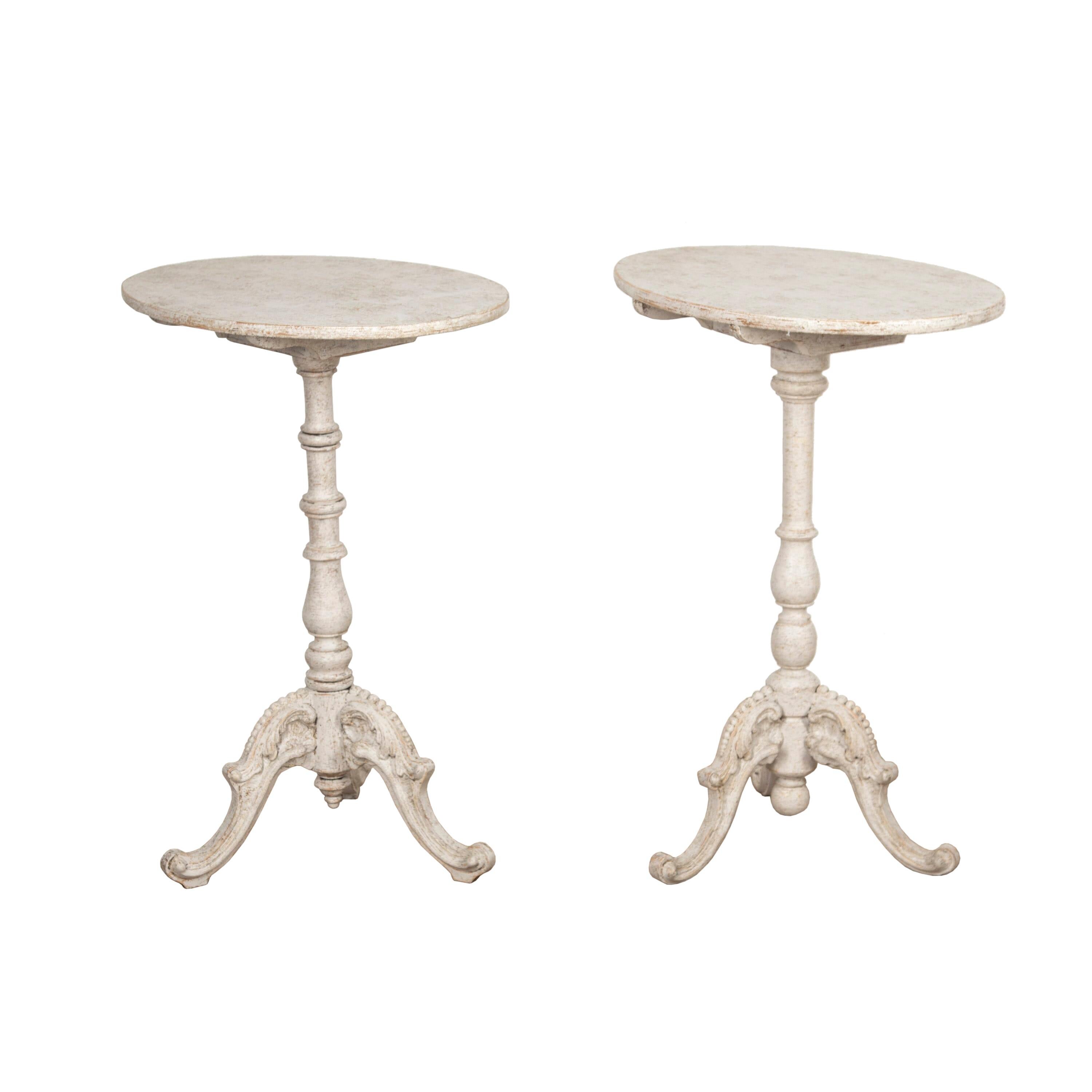 Lovely matched pair of Swedish side tables. 
These wonderful tables have decorative tripod bases and stems which have been wonderfully turned to represent columns. Both have circular tops which are slightly different in size. 
They have been