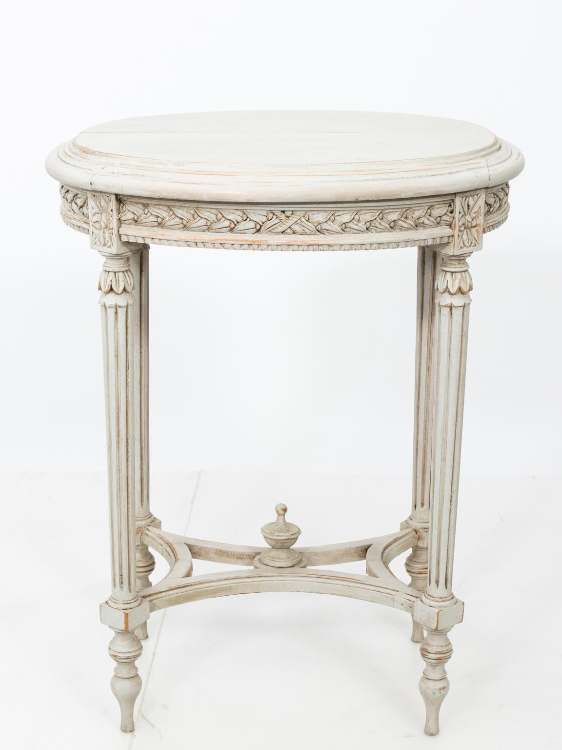 Pair of Swedish painted side tables with cross stretcher, fluted legs, and carved laurel leaf trim on the skirt. Please note of wear with age.