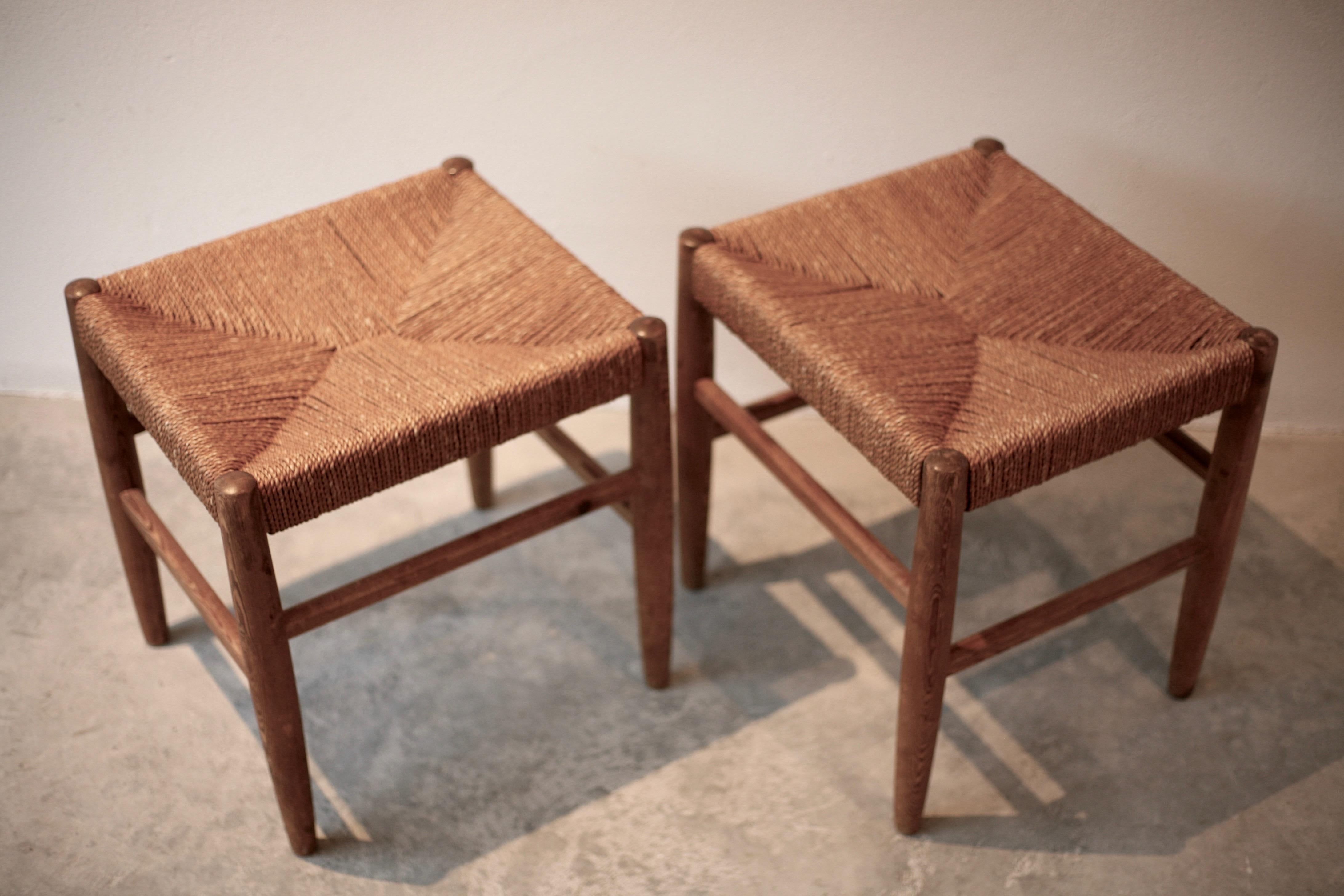 Pair of Swedish pine stools made by Gemla with rush seats of spun papercord. Made in the manner of Gunnar Asplund’s chairs manufactured by the same factory.
