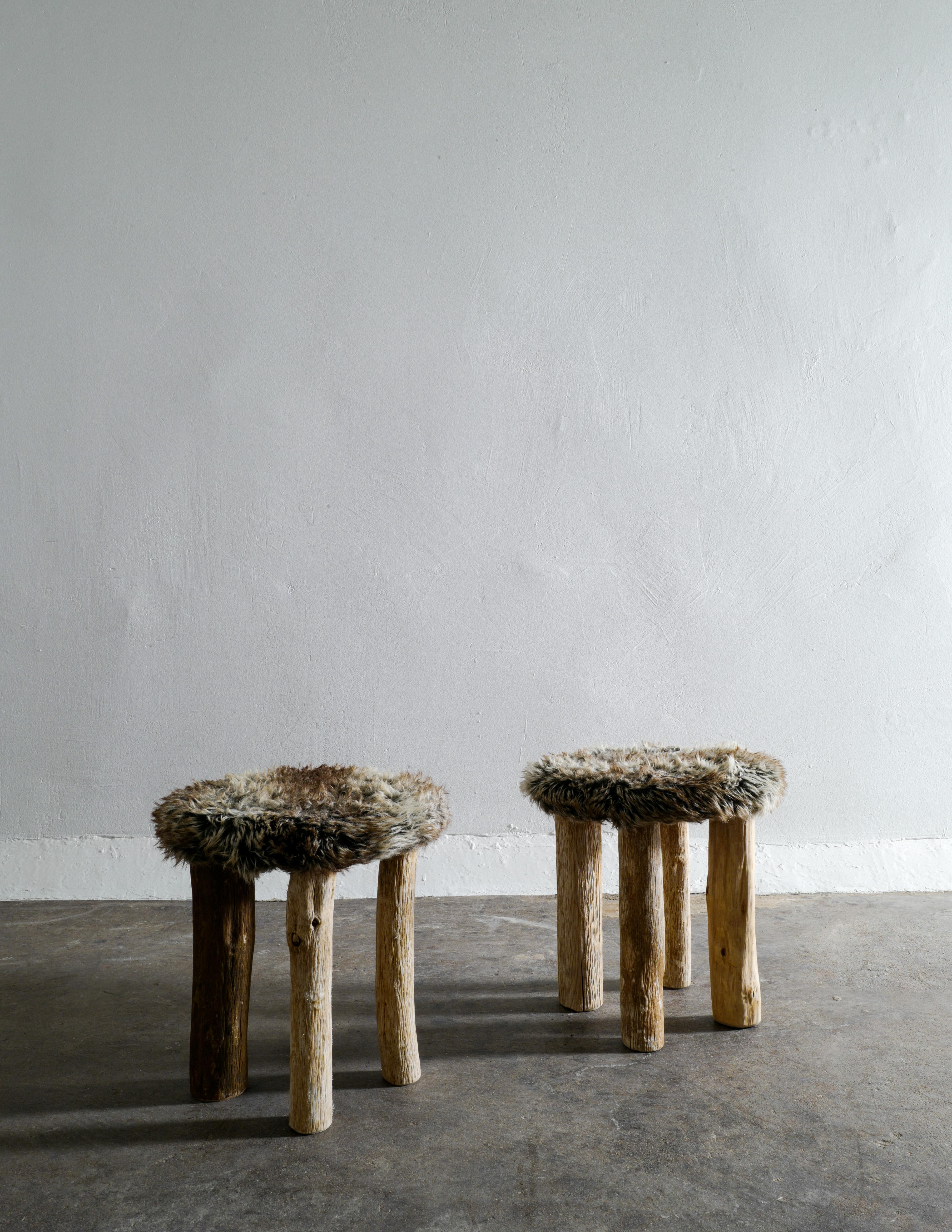 Rare pair of stools in a primitive style produced in Sweden by unknown designer. Stable and in great condition.