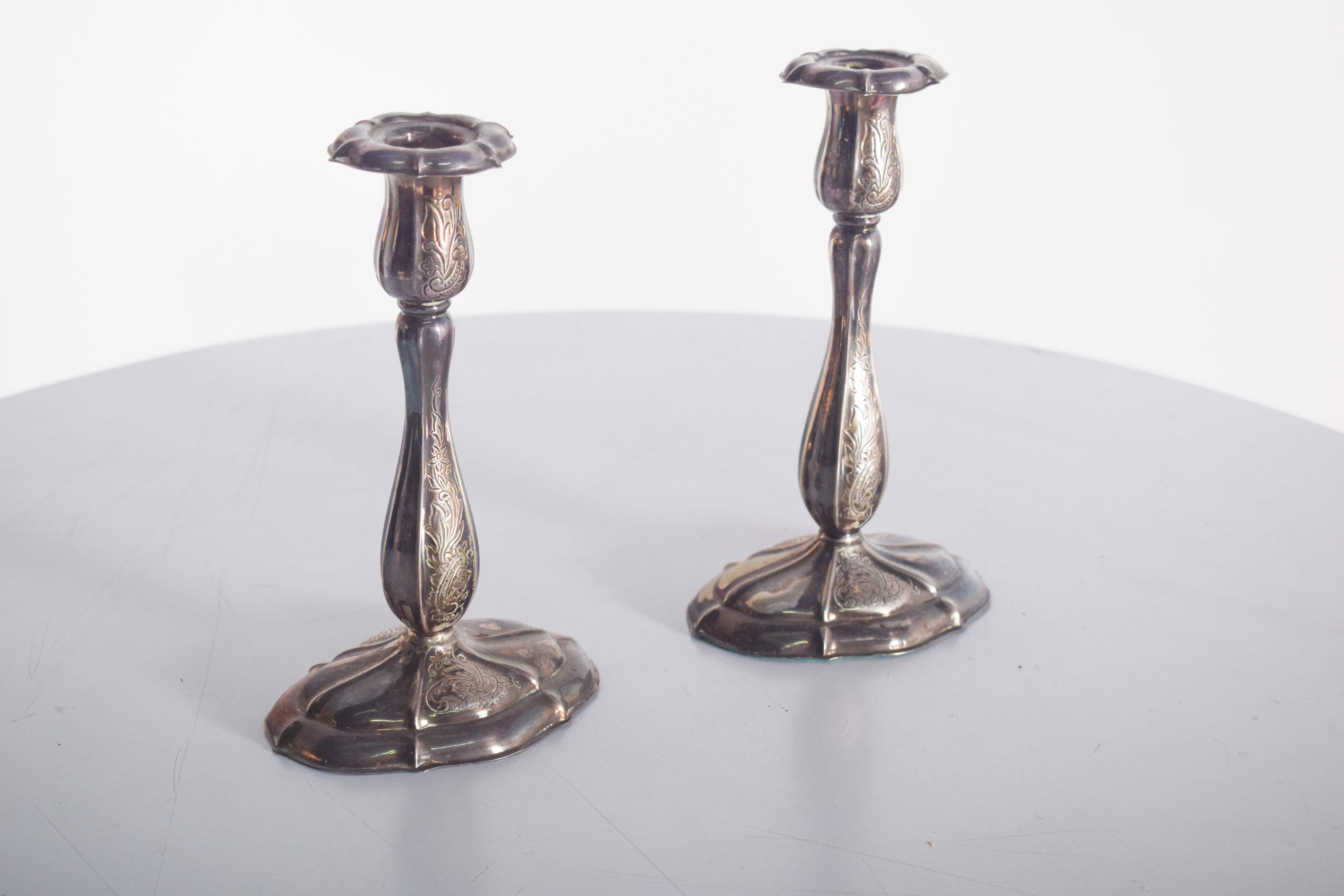 Una splendida coppia di candelieri svedesi in argento, ciascuno dotato di una base rotonda in gomma per una maggiore stabilità. I candelieri sono decorati in modo elegante con intricati motivi floreali e di foglie, che mettono in mostra una