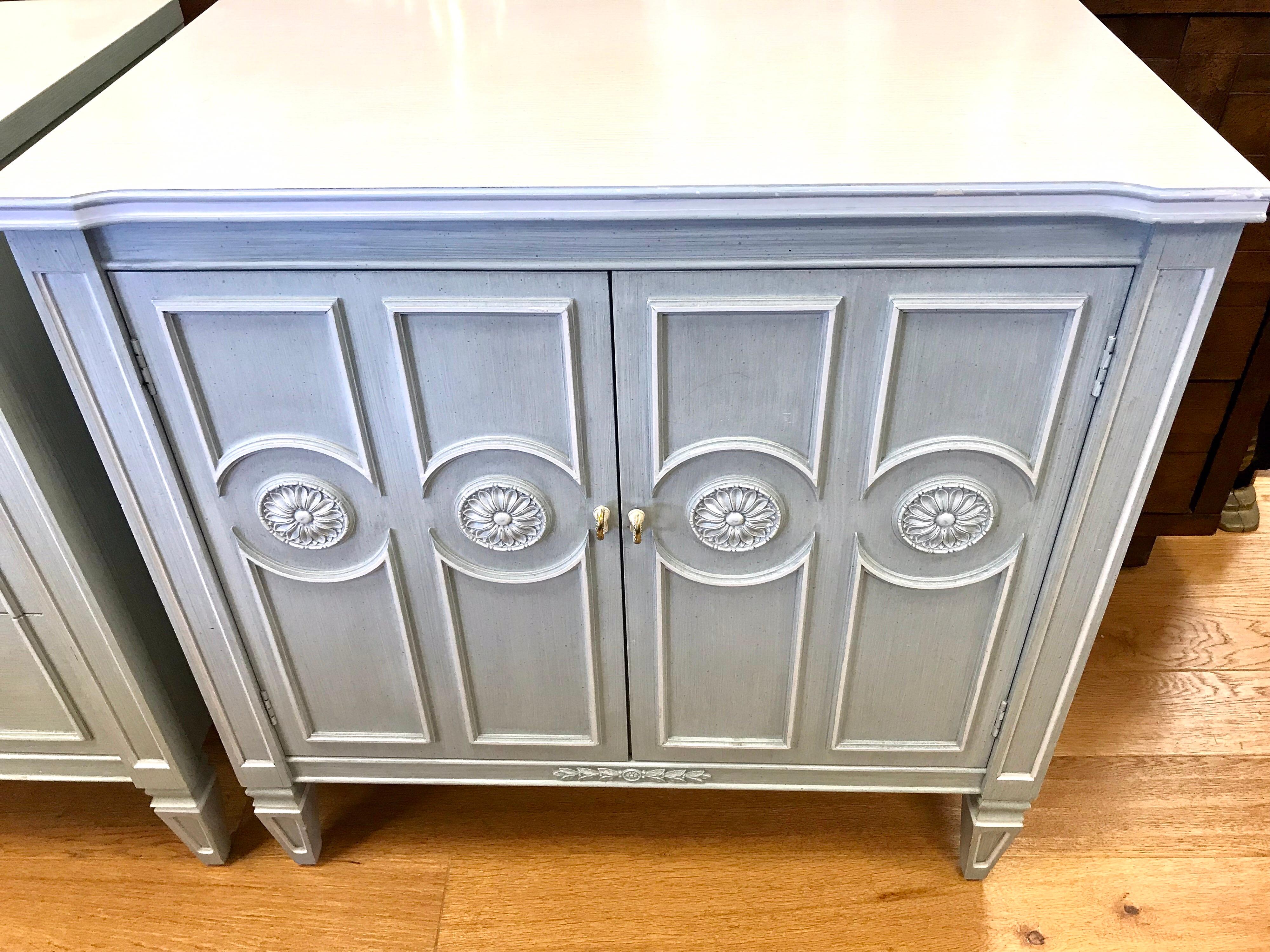 Swedish style painted bedroom set of cabinets in a pretty light blue grey finish with applied medallions and molding.
