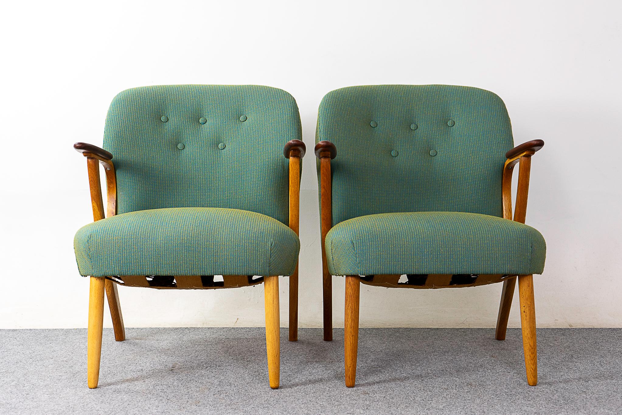 Oak & teak scandinavian lounge chairs, circa 1950's. Curvaceous bent oak frames with splayed legs and contrasting teak armrests. New wool upholstery with button tufted backrests. A very comfortable sit! 

Please inquire for remote and international