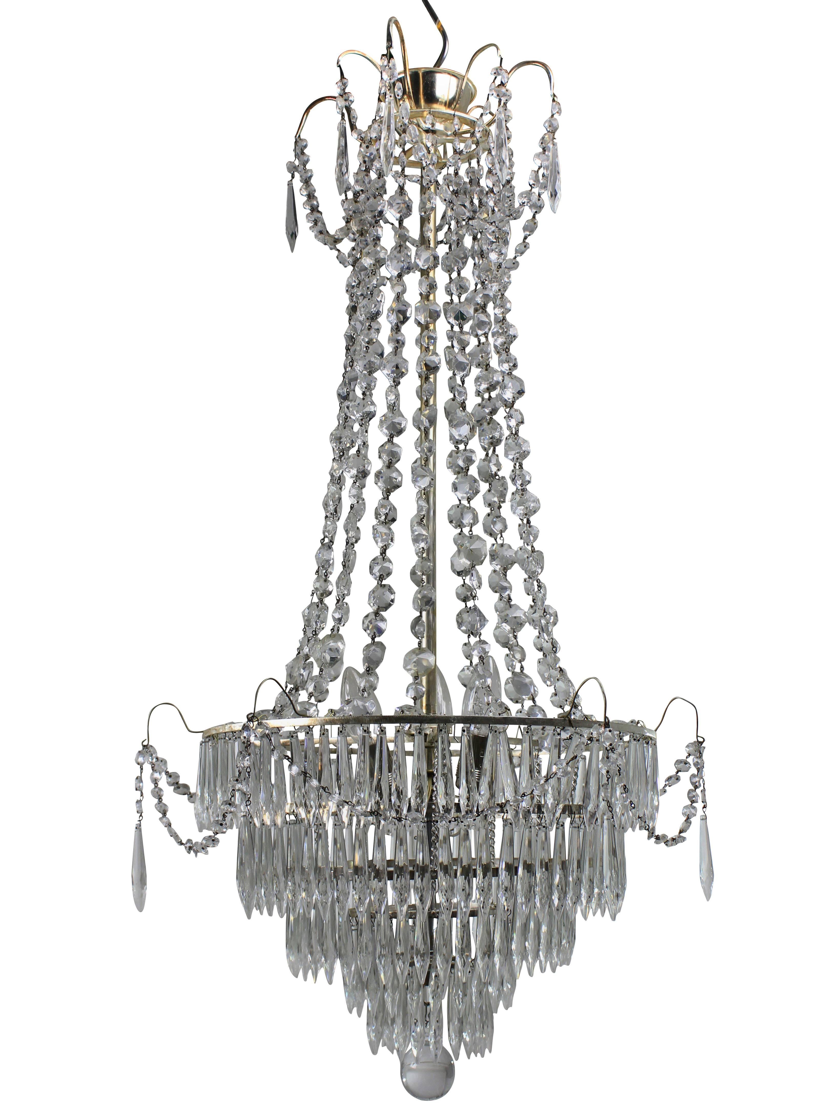 A pair of Swedish chandeliers of simple design in silver plate and hung delicately throughout with cut-glass.