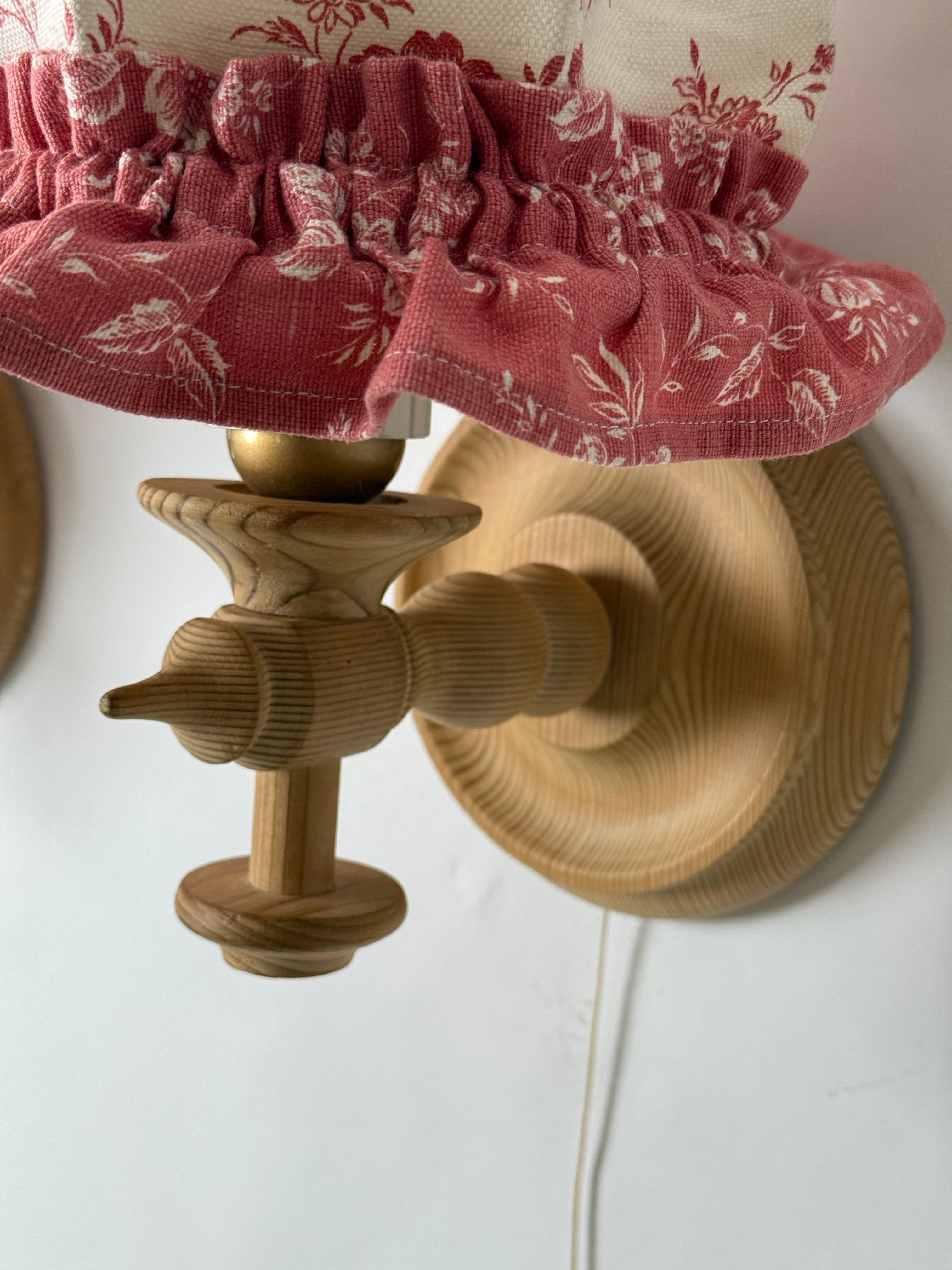 This beautiful, unusual and rare to find pair of wall lights comes from a villa that was decorated in the Scandinavian Alpine style. The wall lights are characterized by their excellent craftsmanship; the wood was selected with great care and a feel