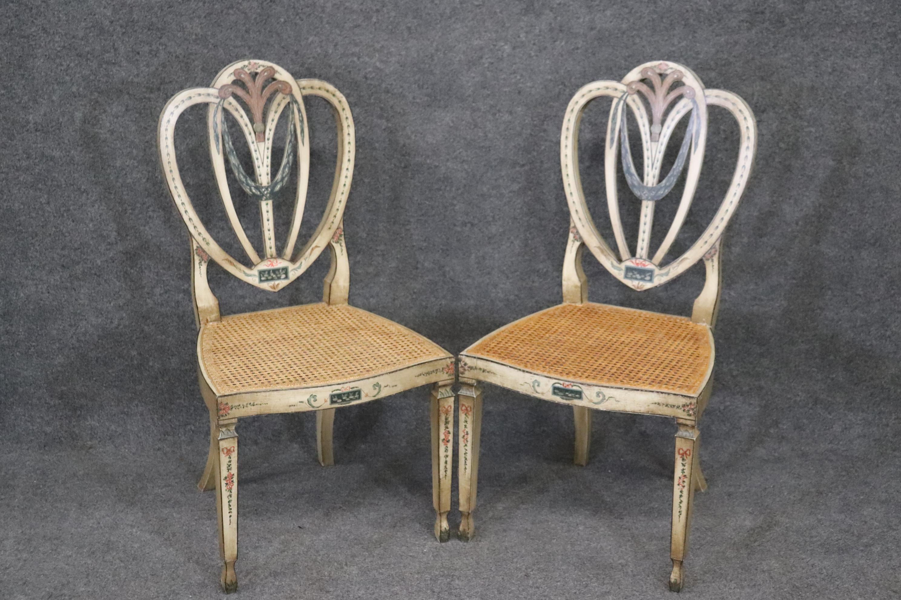 This is a stunning pair of Adams side chairs with good cane seating and beautiful painted floral decoration. The chairs are in good condition for 100 year old chairs. They measure 38.25 tall x 19.5 wide x 20.25 deep and have a 17 inch seat height.
