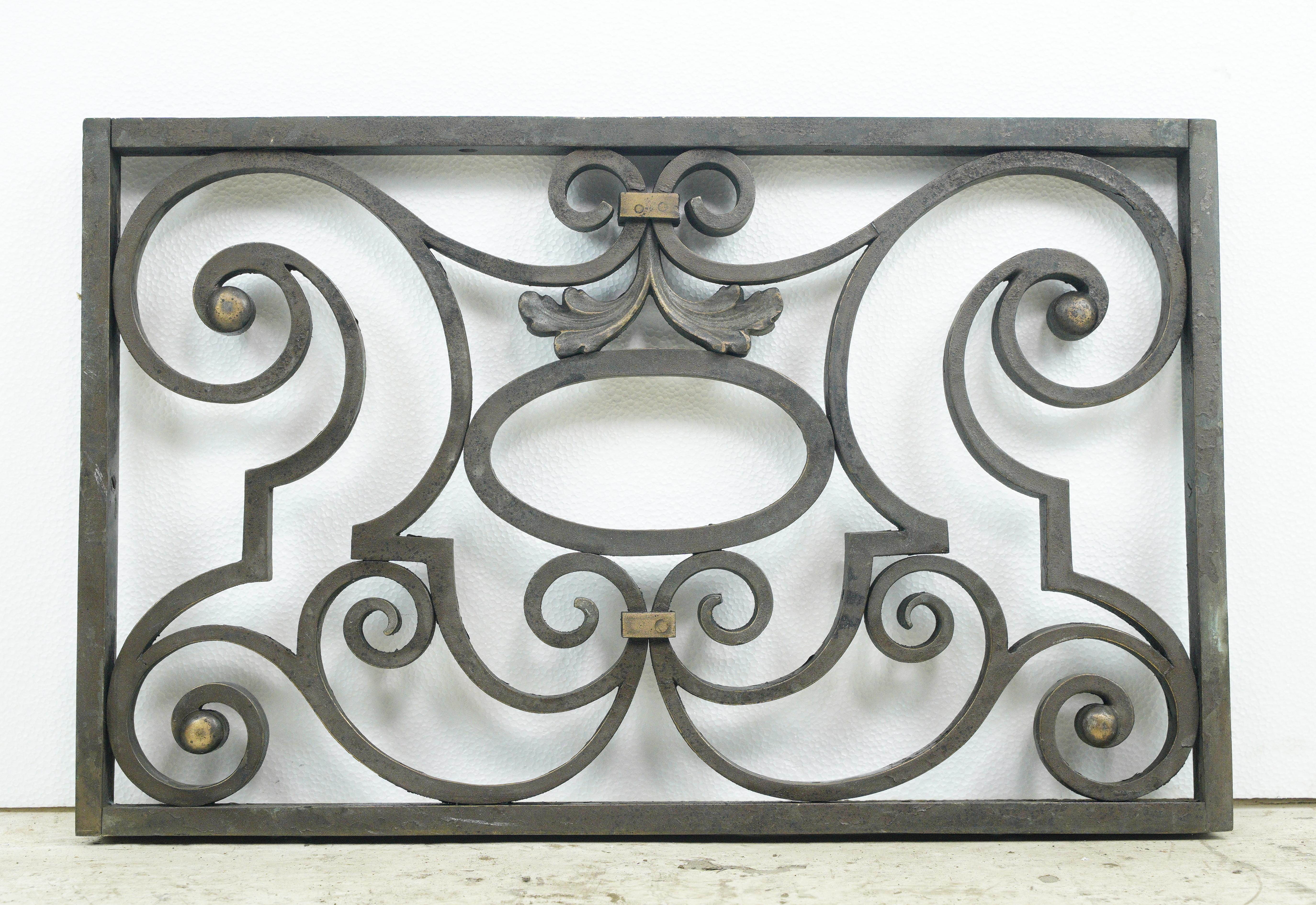 Elevate your windows with this pair of reclaimed cast bronze window guards. The intricate swirl pattern adds elegance and security, blending vintage aesthetics with modern functionality. They are in good condition, with age appropriate surface wear