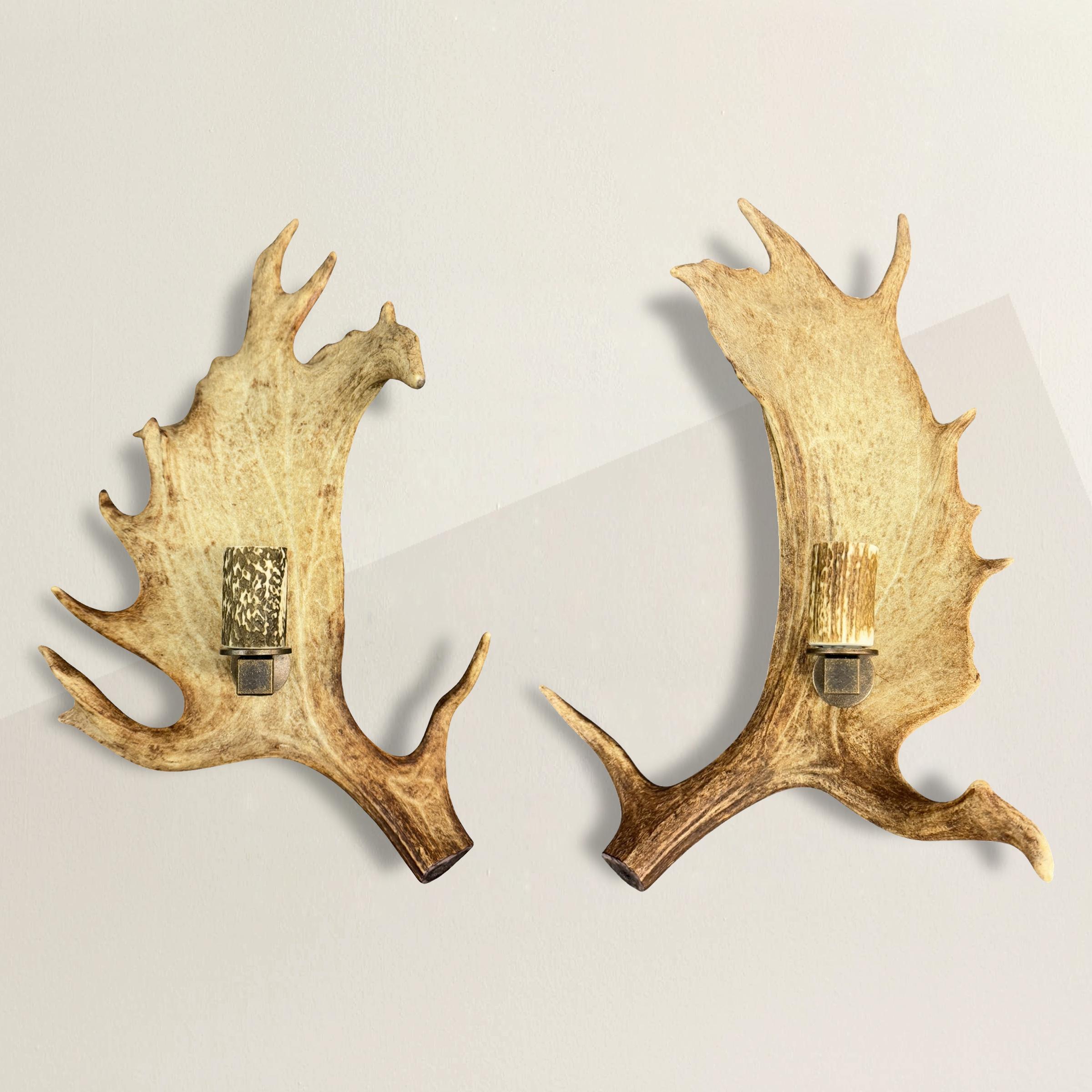 This striking pair of Fallow Deer single-arm sconces, hand-crafted in Switzerland, embodies rustic elegance and artisanal craftsmanship. The naturally textured antlers form the central structure, each gently curving to cradle a single arm, while