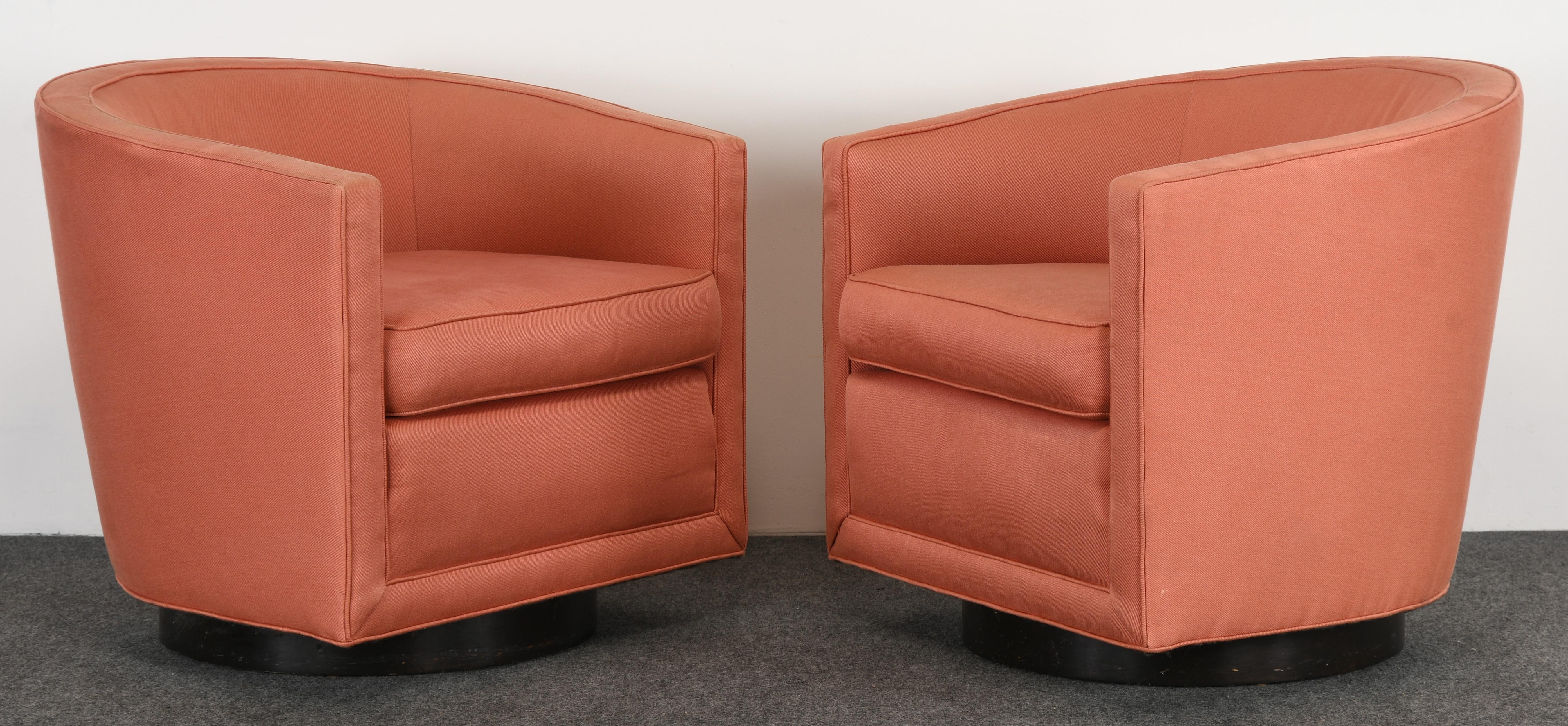 A pair of midcentury swivel chairs on walnut bases designed by Edward Wormley for Dunbar. The chairs are structurally sound with age-appropriate wear. New upholstery recommended.

Dimensions: 27.25