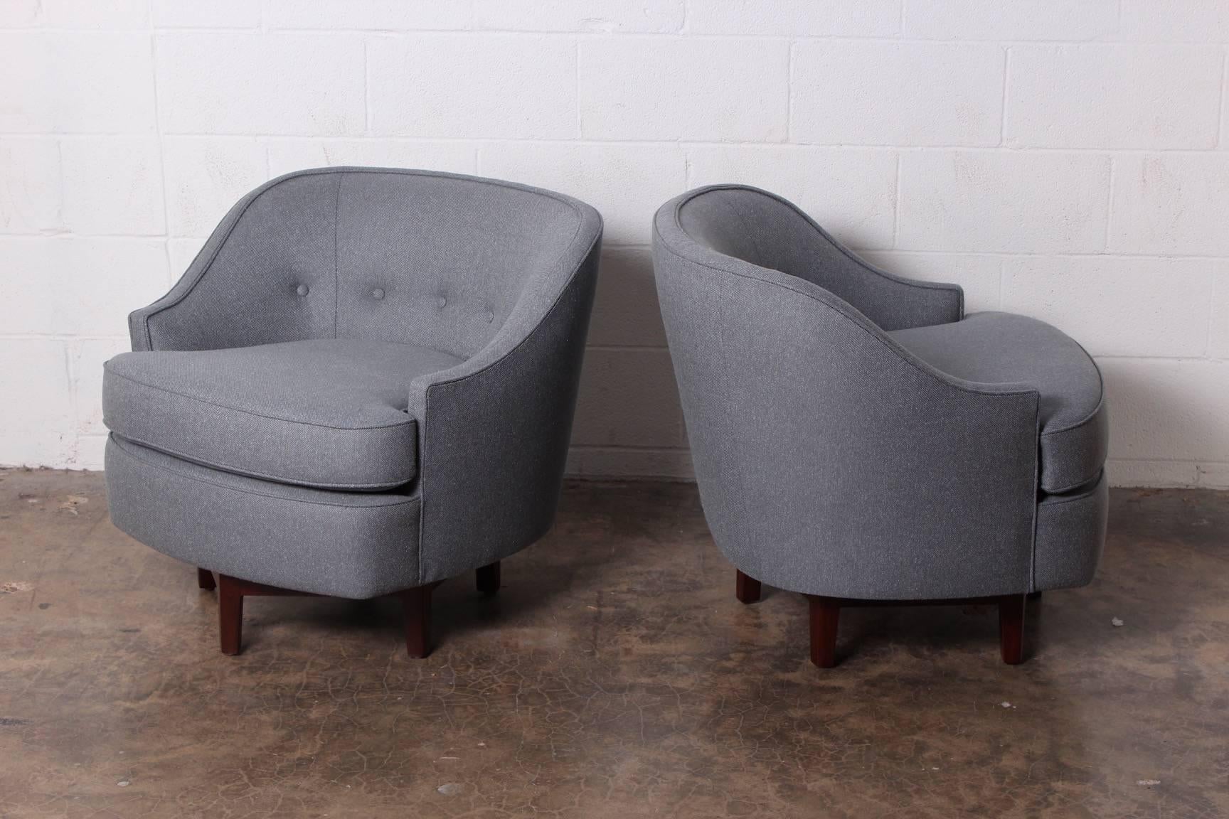 A pair of Janus swivel chairs with hexagonal mahogany bases. Designed by Edward Wormley for Dunbar. Two pairs available.