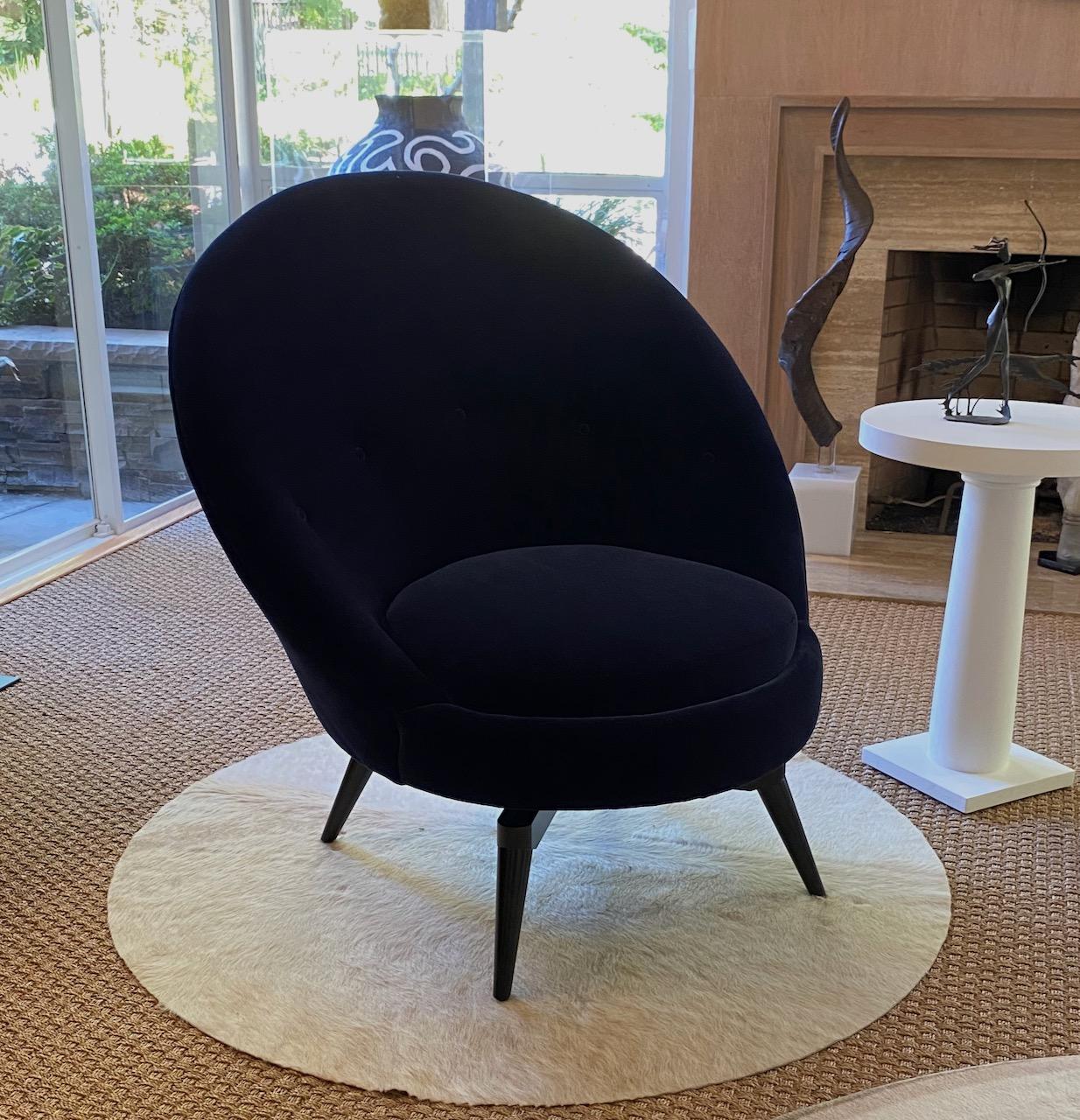 Pair of swivel egg chairs by AdM Bespoke in a luxurious Navy Blue Faux Mohair velvet. The chairs are entirely bench made and upholstered in our local workrooms. The bases are constructed of solid Maple and finished in Espresso lacquer. The chairs