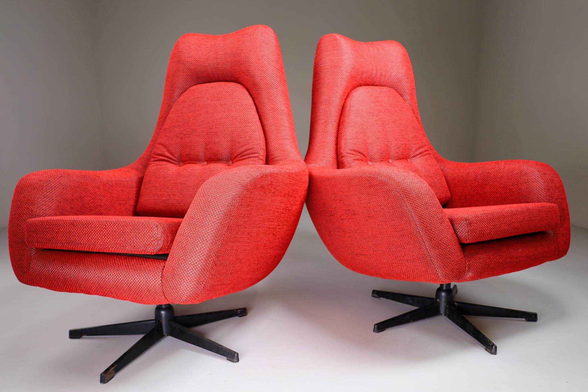 This Swivel chair in new reupholstered red fabric is made in Czech republic around 1970. This armchair would make an eye-catching addition to any interior such as living room, family room, screening room or even in the office. It also perfectly fits