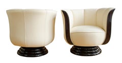 Pair of swivel chairs upholstered in light leather