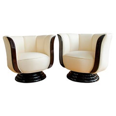 Pair of swivel chairs upholstered in light leather