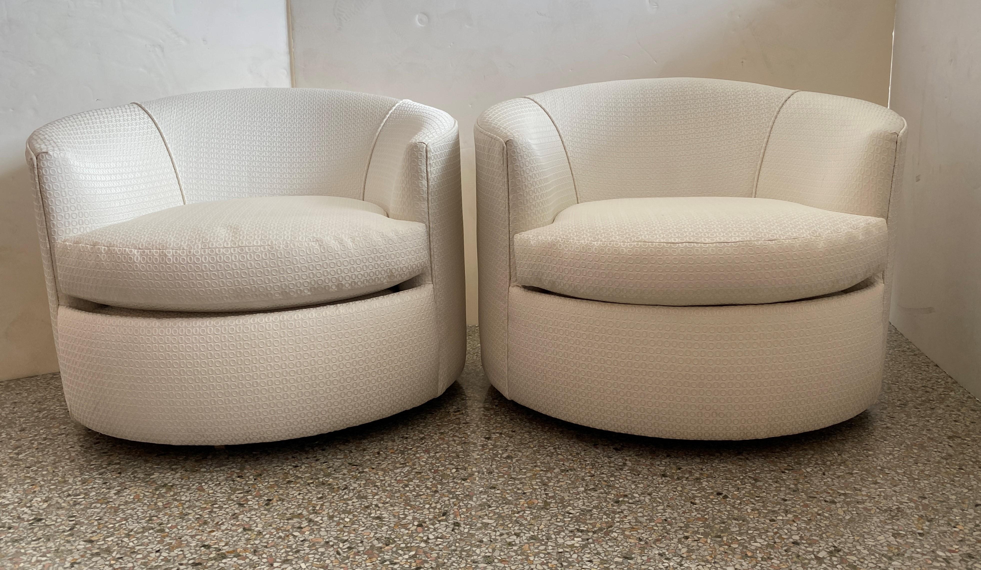 These stylish, low profile swivel club chairs date to the 1970s and have been professionally reupholstered (June 2020) in a woven fabric.

Note: Seat height in the middle of the cushion is 16